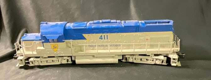 Delaware and Hudson Alco C420 Diesel Locomotive, Road Number 411, attributed to Lionel: This O gauge diesel locomotive is finished in the Delaware and Hudson blue and gray livery with yellow accents. The model represents an Alco C420 Century-series locomotive and is attributed to Lionel 