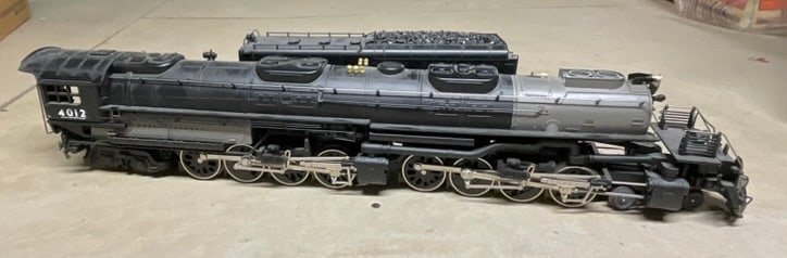 MTH Electric Trains O-Gauge Union Pacific Big Boy 4-8-8-4 Steam Locomotive and Tender 4012: MTH Electric Trains O-gauge model of the Union Pacific Big Boy 4-8-8-4 steam locomotive and matching tender. The model is constructed of die-cast metal with plastic components. It features an articula