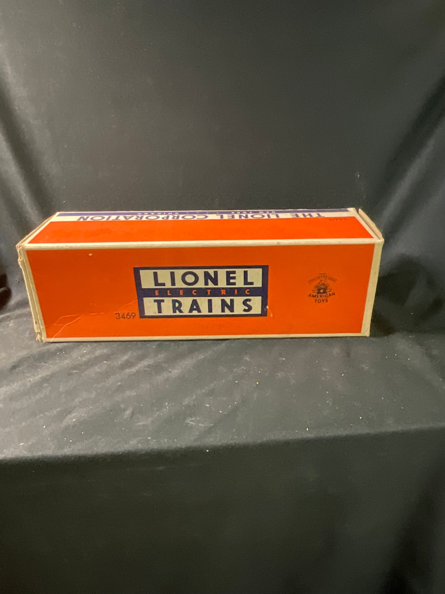 Lionel No. 3469 Automatic Dumping Ore Car with Original Box: This is a postwar O-gauge model railroad freight car manufactured by The Lionel Corporation. Identified as Model No. 3469, this Automatic Dumping Ore Car features a die-cast metal body and chassis wit