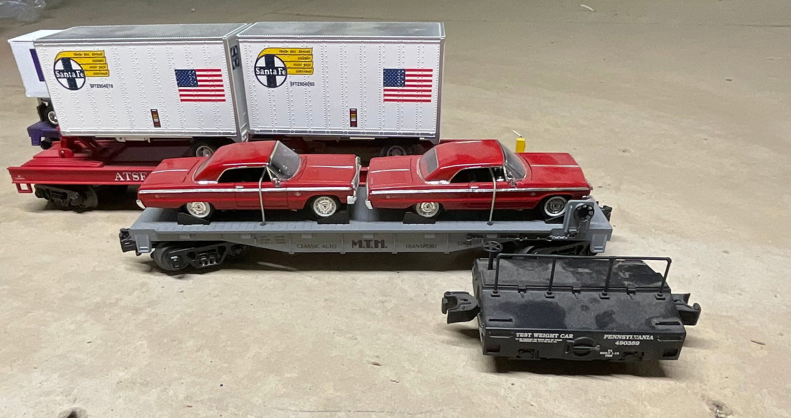 A Collection of M.T.H. RailKing O-Gauge Flatcars and a Test Weight Car (1 of 16)