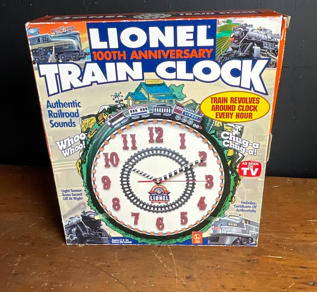 Lionel 100th Anniversary Animated Train Wall Clock Item No. 7183: This is a Lionel 100th Anniversary Train Clock, produced in 1999 to commemorate the brand centennial spanning from 1900 to 2000. The battery-operated wall clock features a quartz movement and an integ