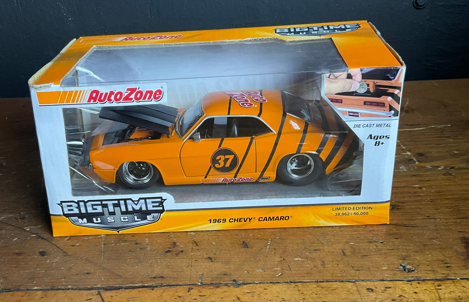 Jada Toys 1:24 Scale 1969 Chevy Camaro Die-Cast Coin Bank AutoZone Promotional Limited Edition: This die-cast model car coin bank is part of the Bigtime Muscle series produced by Jada Toys as a promotional item for AutoZone. The vehicle is a 1969 Chevrolet Camaro finished in orange with black ra