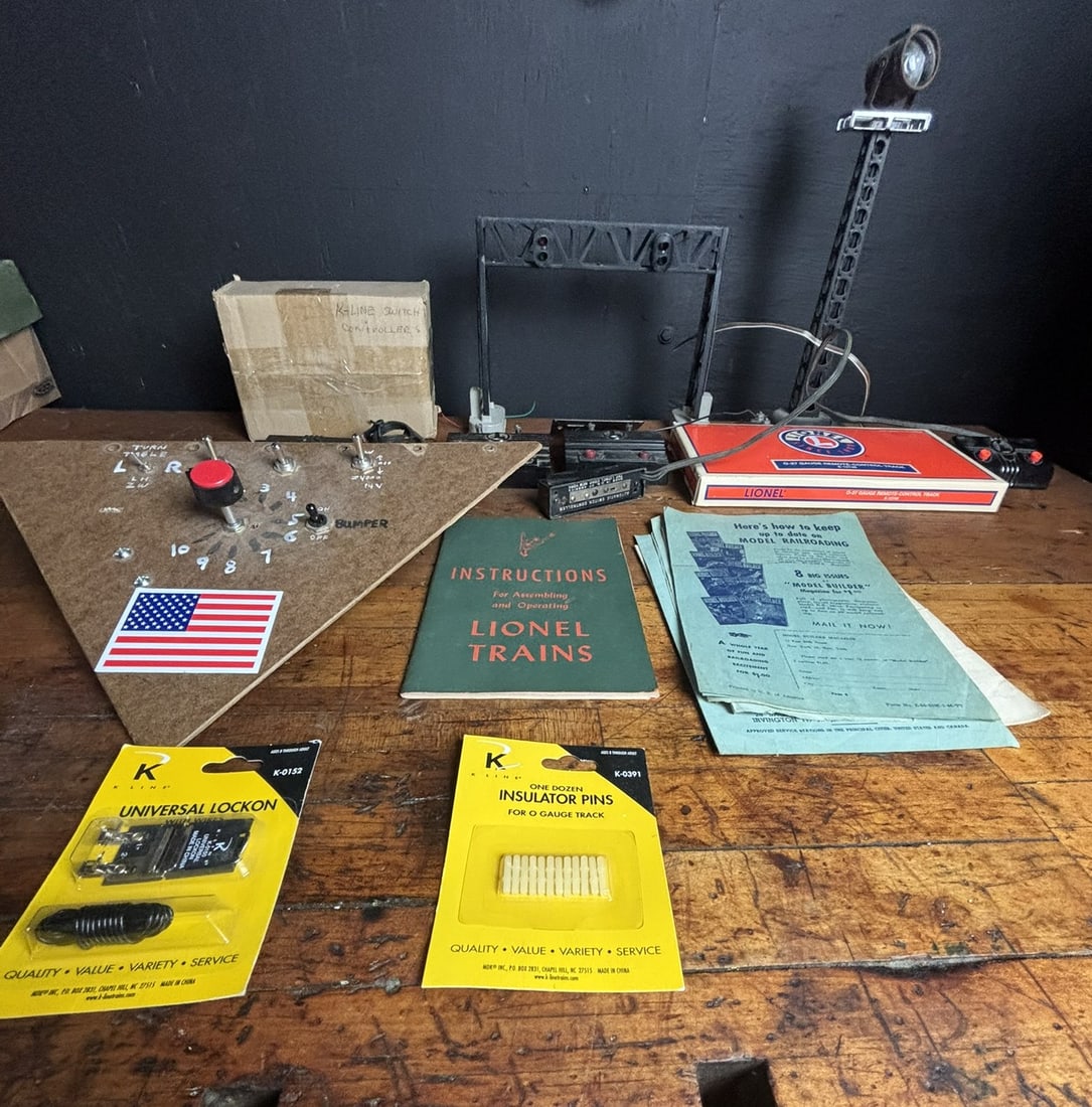 A Collection of Vintage and Modern Lionel and K-Line Model Railroad Accessories and Ephemera: This collection features a diverse assortment of model railroad accessories, controllers, and printed materials primarily from Lionel and K-Line. The lot includes a Lionel O-27 Gauge Remote-Control Tr