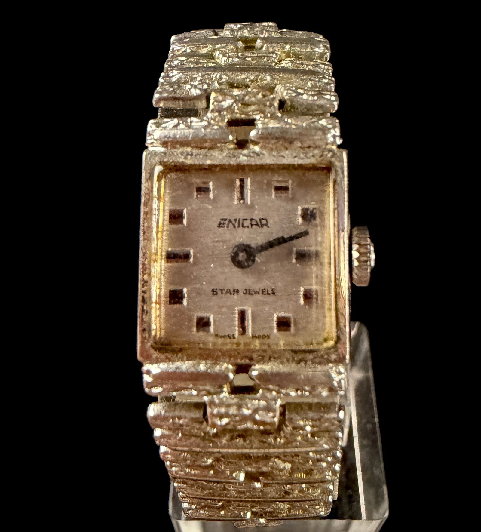 Enicar Star Jewels Vintage Ladies Manual Wind Wristwatch 2706: A vintage Enicar Star Jewels ladies' wristwatch featuring a manual wind Swiss movement. The timepiece is designed with a square case and a silver-toned dial that exhibits a vertical brushed finish. Th