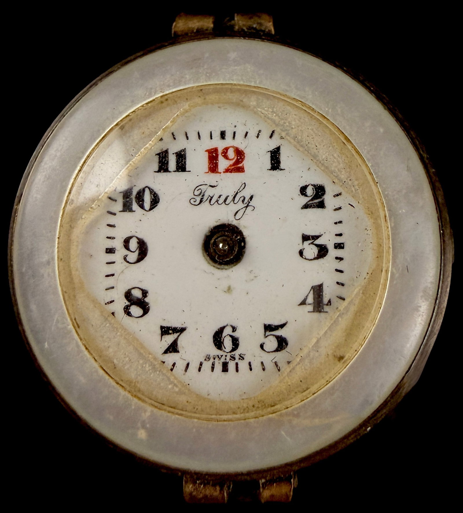 Truly Swiss Manual Wind Mother-of-Pearl Pendant Watch: This is an antique Swiss-made ladies pendant watch featuring the brand name Truly on the dial. The circular case is constructed of gold-tone plated base metal with inset iridescent mother-of-pearl pan