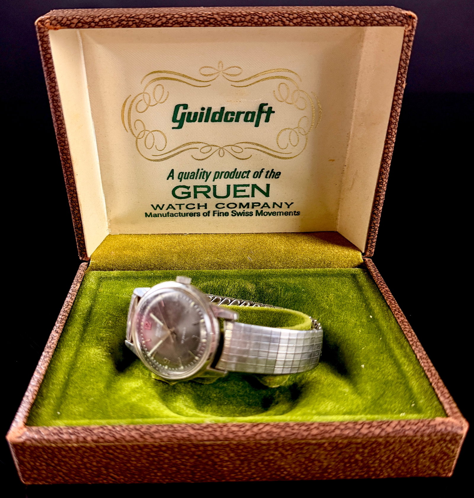 Vintage Gruen Precision Manual Wind 17 Jewel Stainless Steel Wristwatch with Original Guildcraft Box: A vintage Gruen Precision mechanical wristwatch featuring a 17 jewel manual wind movement. The watch is housed in an all stainless steel case and is accompanied by its original brown textured Guildcra