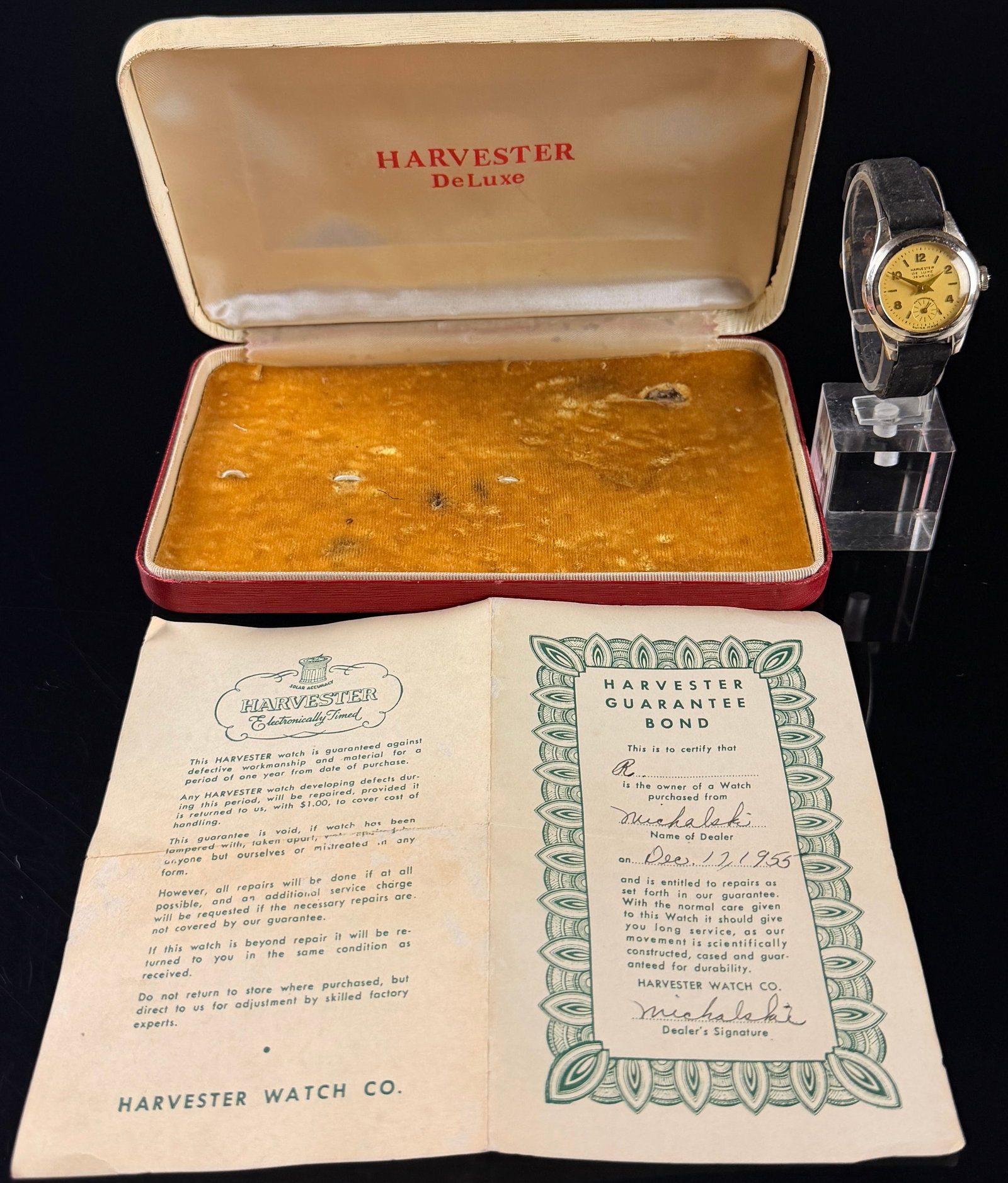 Vintage 1955 Harvester De Luxe Manual Wind Wristwatch with Box and Papers, Does Not Run: This vintage Harvester De Luxe wristwatch is presented with its original manufacturer box and matching provenance paperwork. The timepiece features a Swiss-made manual wind movement with one jewel, si