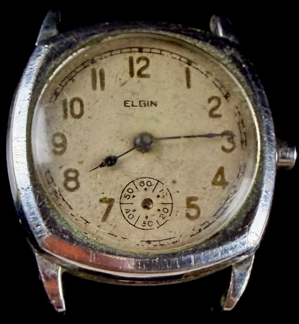 Vintage Elgin Cushion Case Manual Wind Wristwatch: This vintage Elgin manual wind wristwatch features a cushion-shaped base metal case manufactured by the Star Watch Case Company. The dial is finished in an aged cream color with Arabic numeral hour ma