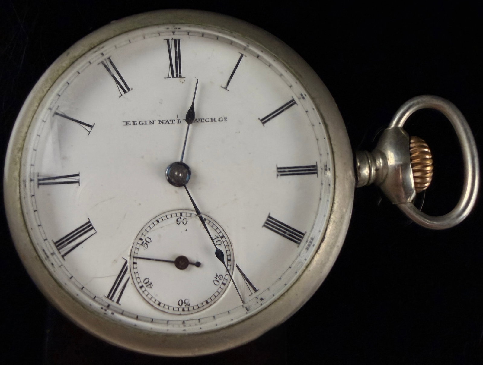 Elgin National Watch Co. Size 18s Open-Face Pocket Watch with Lever-Set Movement: This antique Elgin National Watch Co. pocket watch features an 18-size manual wind movement in an open-face "sidewinder" configuration, with the winding stem positioned at 3 o'clock. The movement is l