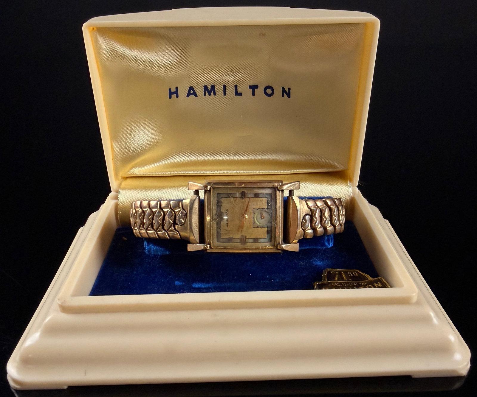 Vintage Hamilton Caliber 752 10K Gold Filled Tank Style Watch with Box and Papers 26mm: This vintage Hamilton manual wind wristwatch features a square tank style case with distinctive Art Deco lugs. The watch is powered by a caliber 752 17-jewel manual wind movement, made in the USA, wit