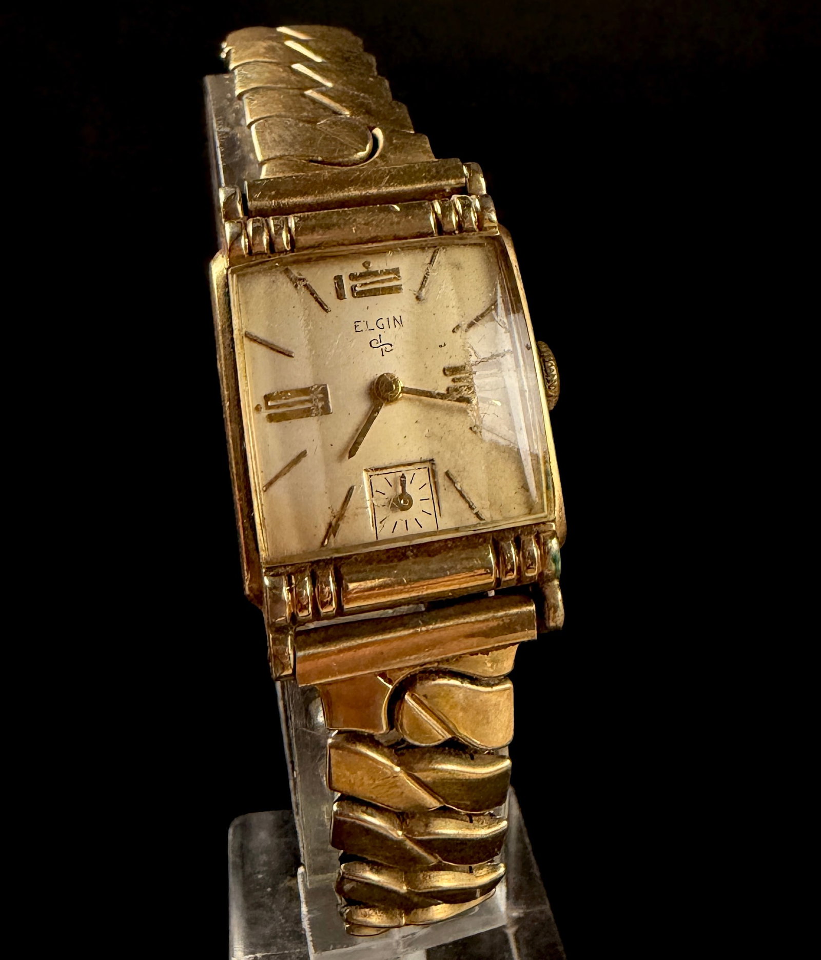 Elgin DuraPower 10K RGP Rectangular Men's Wristwatch Does Not Run: A mid-century vintage Elgin DuraPower manual wind mechanical wristwatch. The timepiece features a rectangular tank style case with decorative stepped lugs. The case construction consists of a 10 karat