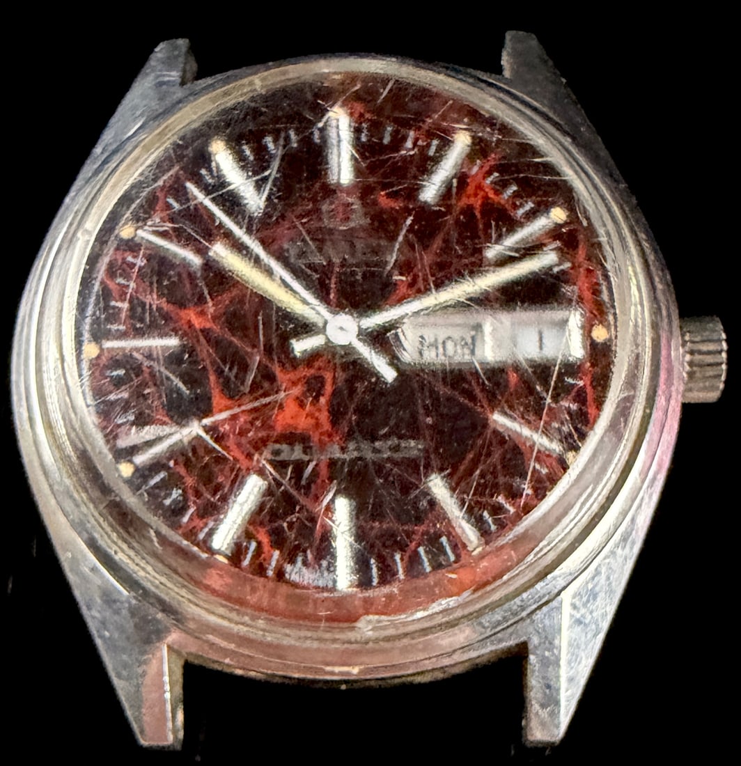 Vintage Timex Q Quartz Red Nebula Day-Date Wristwatch Head: This lot consists of a vintage Timex Q Quartz wristwatch head, identified through web consensus as the Red Nebula model dating to circa 1978. The watch features a marbled spider dial in shades of deep