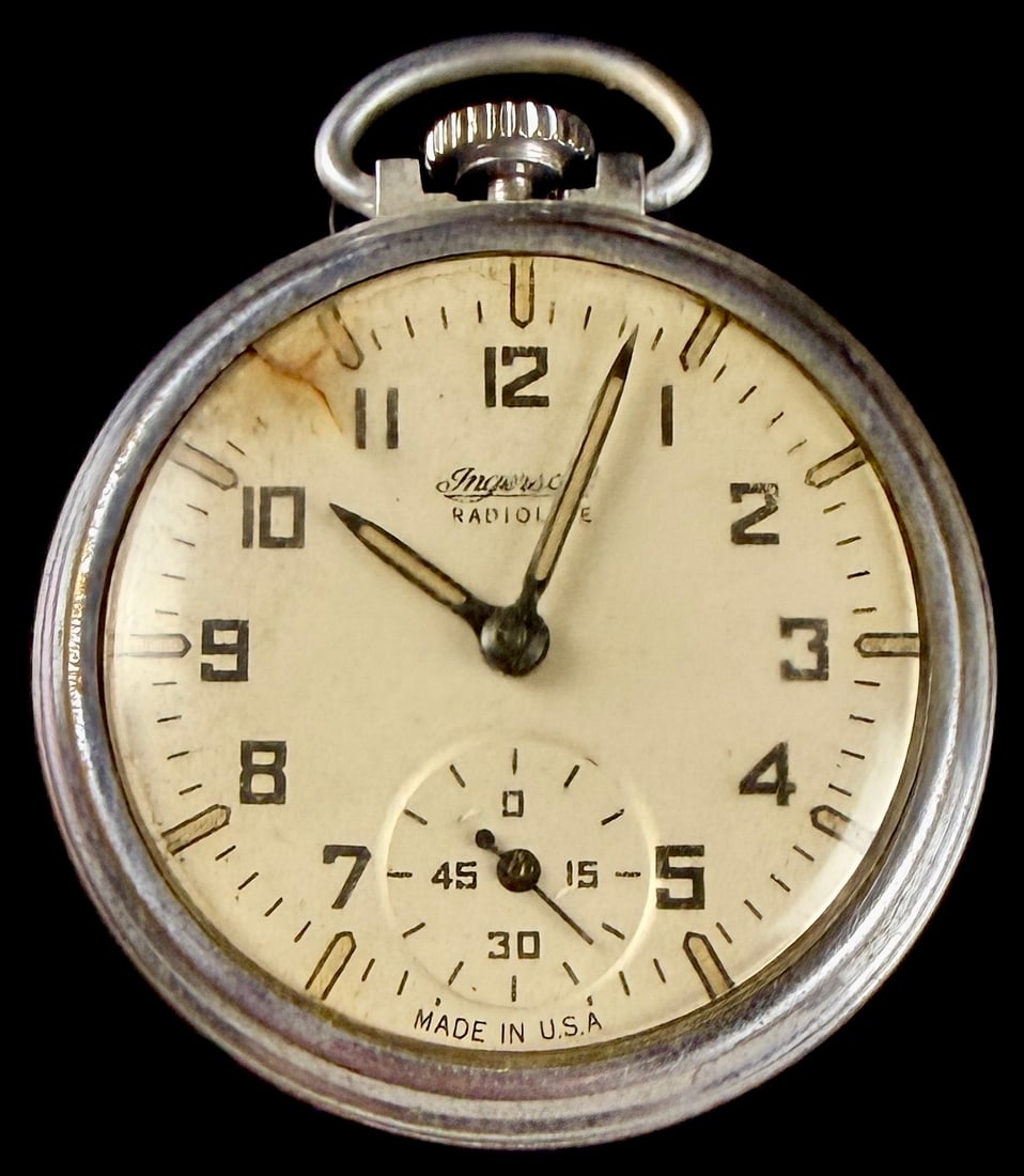 Ingersoll Yankee Radiolite Nickel Plated Pocket Watch: An open-face pocket watch produced by Ingersoll, identified as the Yankee Radiolite model. The cream-colored dial features bold black Arabic numerals, cathedral-style hands with aged luminous material