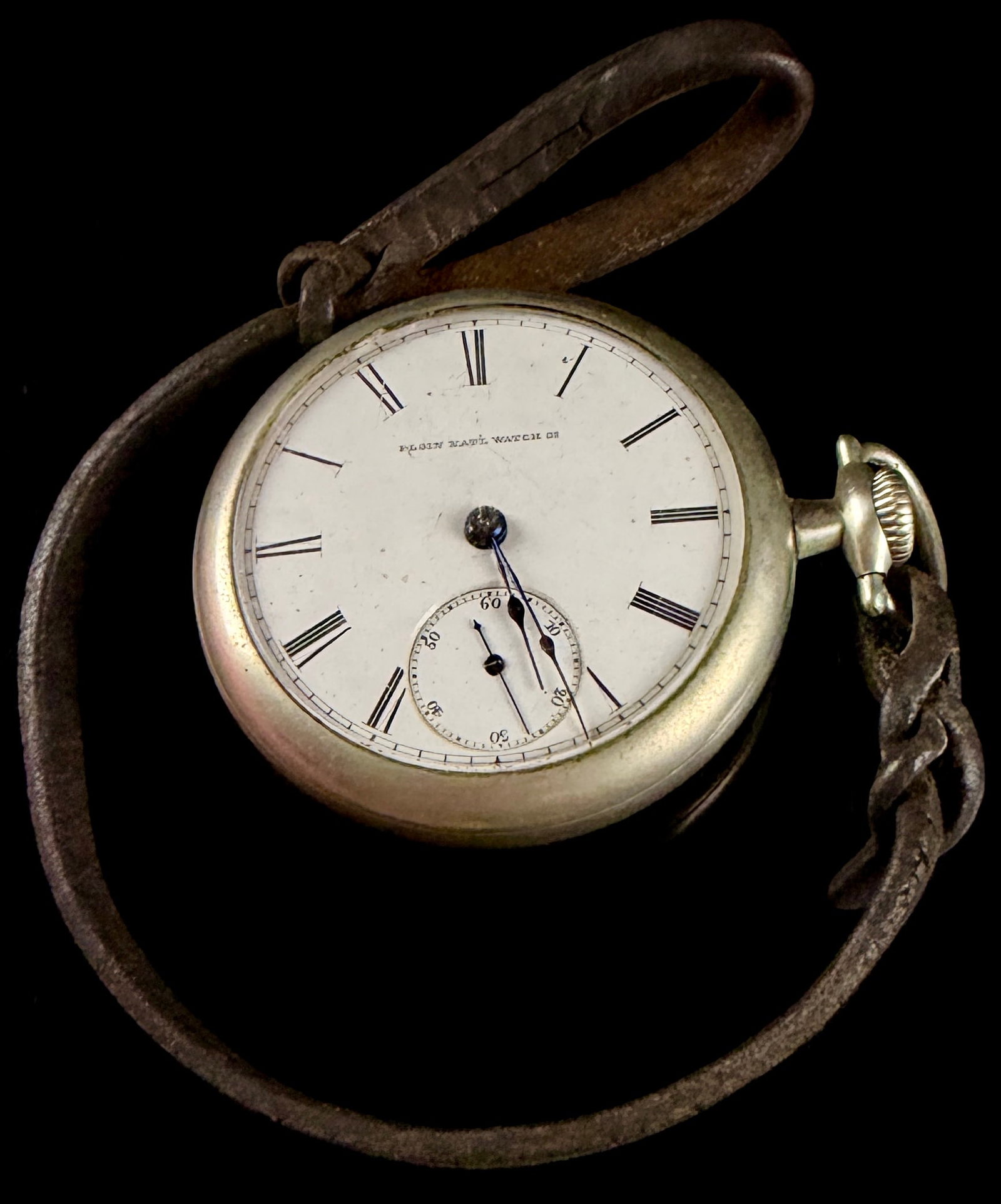 Elgin National Watch Company 18-Size Open Face Pocket Watch Grade 7 Model 1 1881: An antique open-face pocket watch manufactured by the Elgin National Watch Company. This size 18 watch features a white enamel dial with black Roman numeral hour markers, a rail track minute ring, and
