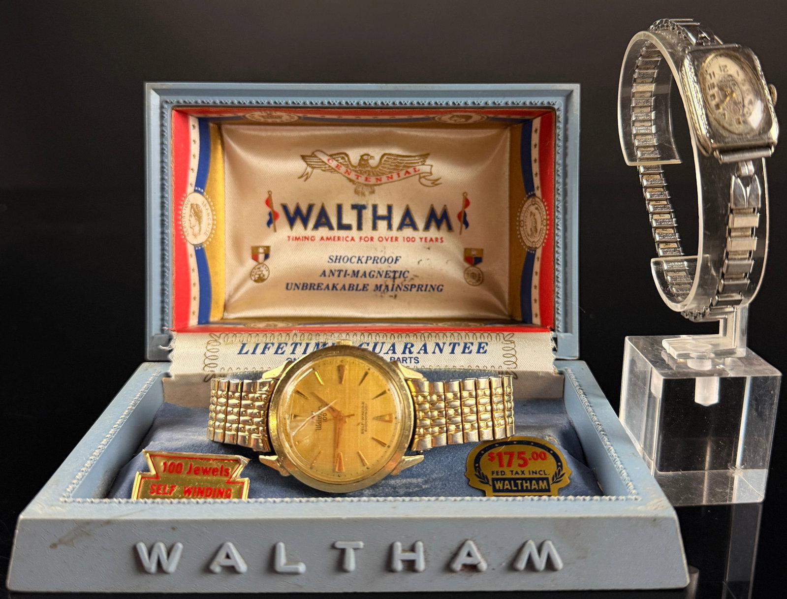 Two Vintage American Wristwatches Including Waltham Centennial 100 Jewel and Elgin Art Deco: This lot features two vintage American-market wristwatches. The first is a Waltham 100 Centennial Series men's automatic wristwatch. The timepiece features a 10 karat gold filled case manufactured by 