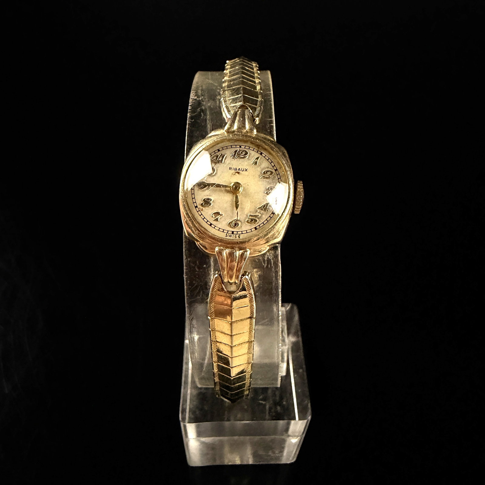 Ribaux 17 Jewel Ladies Manual Wind Wristwatch in 10K Gold Filled Wadsworth Case: This vintage Ribaux ladies wristwatch features a manual wind mechanical movement housed in a 10K gold filled case manufactured by Wadsworth. The watch has a cream colored dial with applied gold tone A
