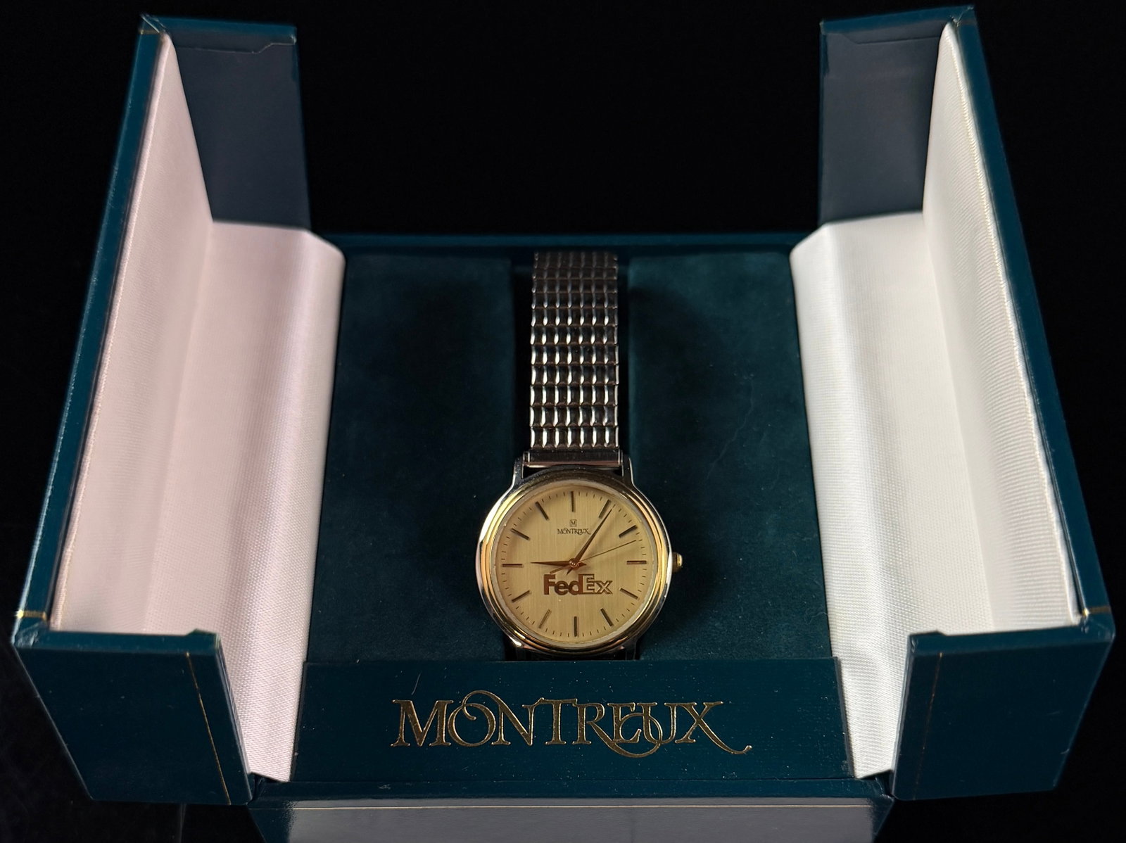 Montreux FedEx 10 Year Service Award Two Tone Quartz Wristwatch with Box and Papers: This corporate recognition wristwatch was produced by Jostens for the Montreux brand as a ten year service award for FedEx. The timepiece features a round two-tone base metal case with a gold-tone bez