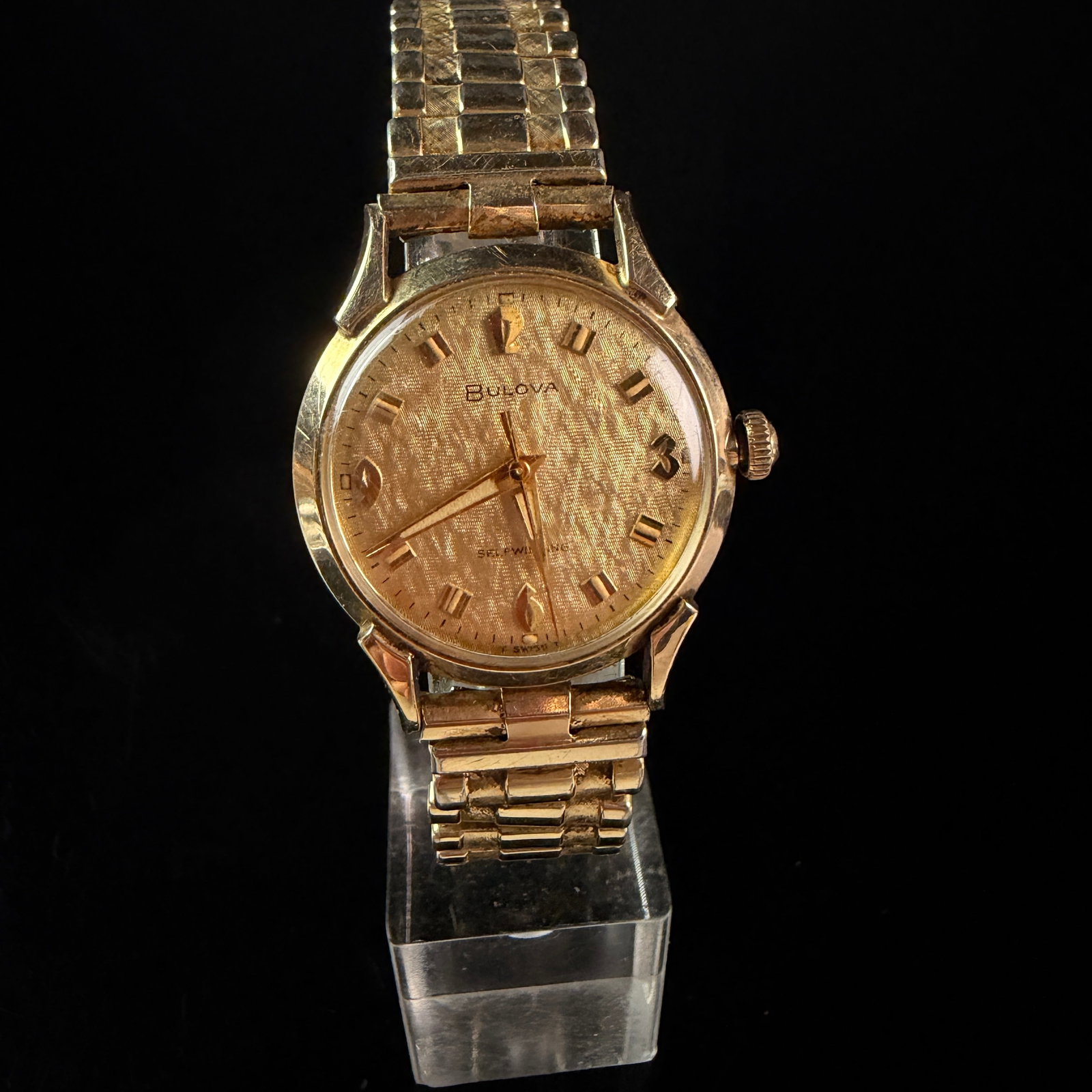 Bulova 1965 Self-Winding H999100 10K RGP Linen Dial Men's Wrist Watch: A vintage Bulova men's wrist watch, reference H999100, manufactured in 1965 as indicated by the M5 date code on the case back. The timepiece features a self-winding automatic movement, and the watch r