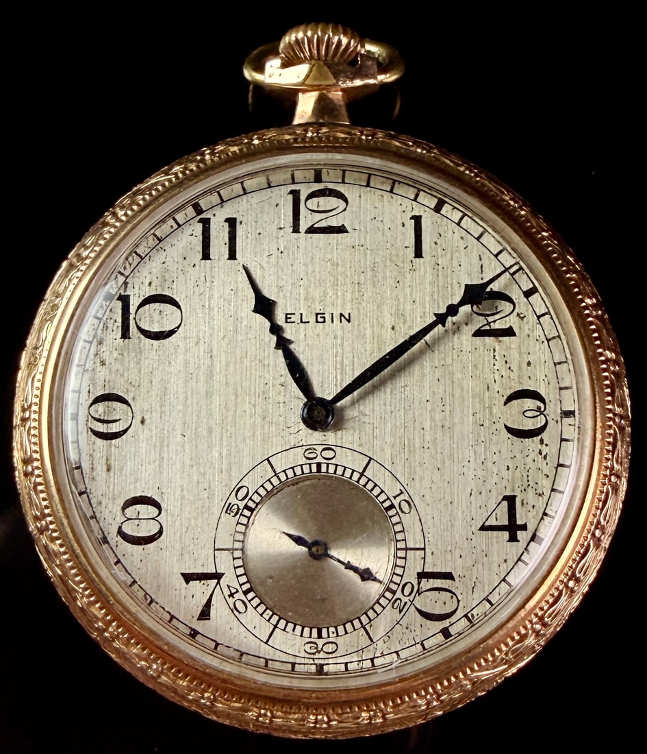 Elgin 10K Gold Filled 15 Jewel Open Face Pocket Watch Size 12s: This is an American open-face pocket watch manufactured by the Elgin National Watch Company. The movement is marked with serial number 27056069, dating its production to approximately 1924. The manual