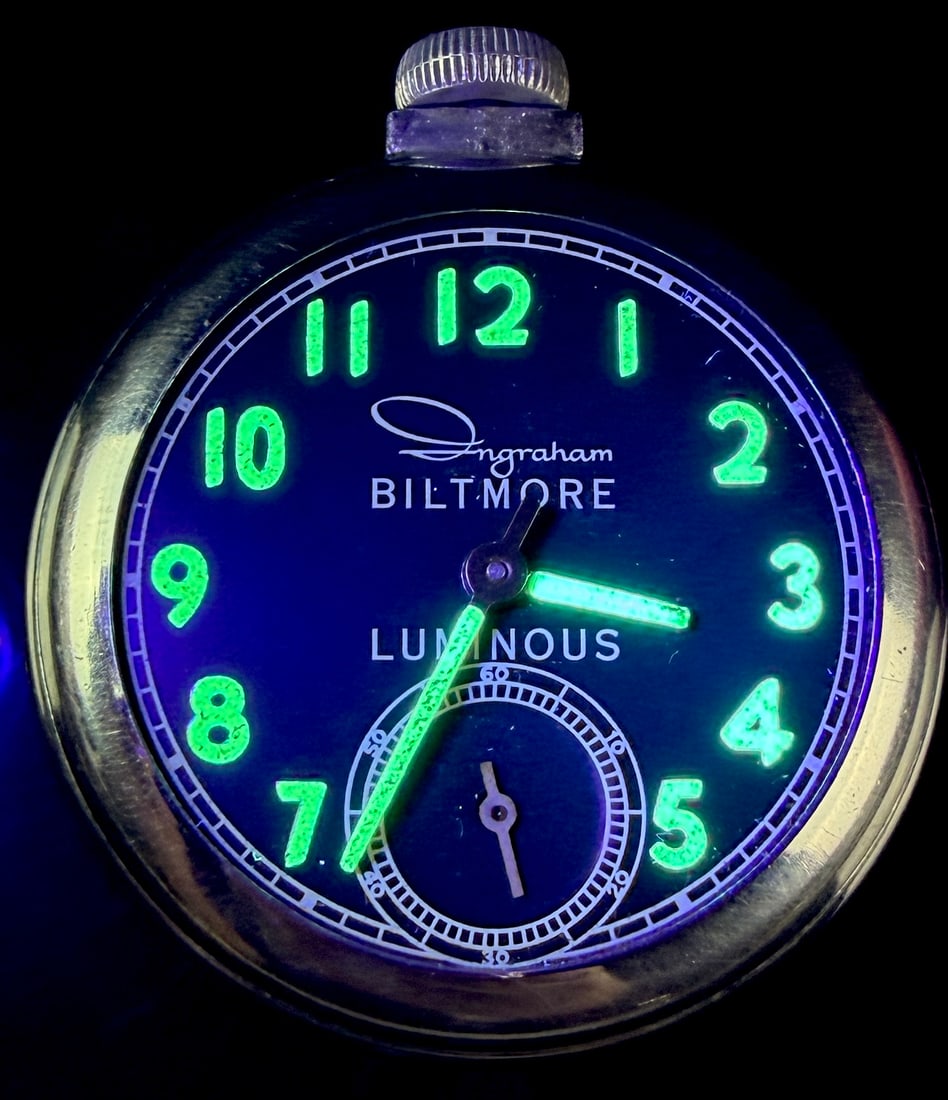 Ingraham Biltmore Luminous Uranium Dial Manual Wind Pocket Watch: An Ingraham Biltmore pocket watch featuring a black dial with luminous Arabic numerals and cathedral-style hands. The dial is marked with the Ingraham logo in stylized script above the block text BILT