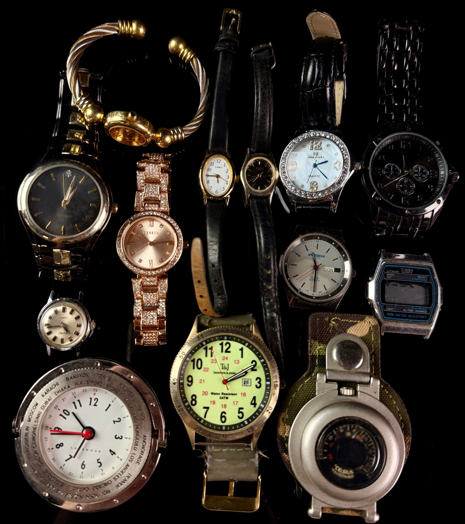 A Collection of Vintage and Modern Wristwatches including Timex, Elgin, and Levenger: A diverse assortment of timepieces including vintage electric, mechanical, and modern quartz wristwatches. The collection features a Levenger world time clock with a rotating city bezel and 24-hour in