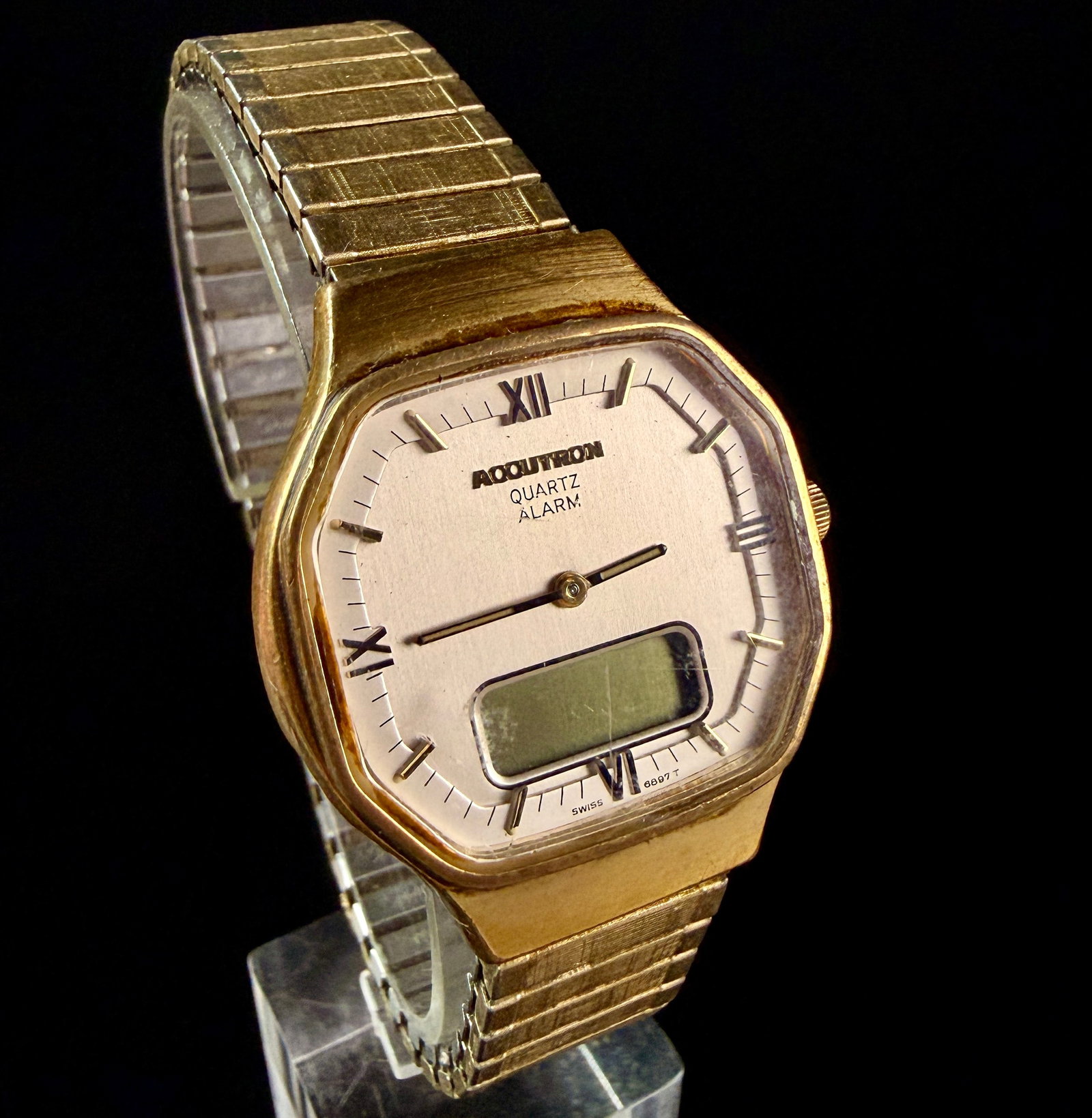 Bulova Accutron Ana-Digi Quartz Alarm Wristwatch Reference 6897 T: A vintage Bulova Accutron analog-digital quartz alarm wristwatch. The timepiece features an octagonal gold-plated base metal bezel and a stainless steel snap-back case. The brushed silver-tone dial is