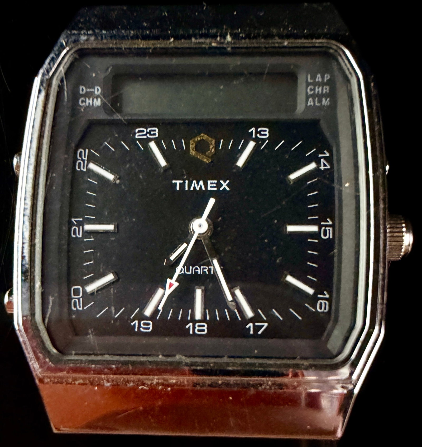 Vintage Timex V Cell Ana-Digi Quartz Watch Head Reference 09: This vintage Timex V Cell Ana-Digi watch features a dual-display design incorporating both analog and digital elements. The watch head is constructed with a chrome-plated base metal bezel and a