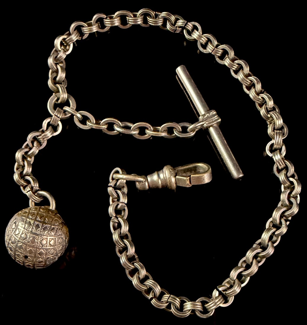 Antique White Metal Single Albert Watch Fob Chain with T-Bar and Spherical Fob: This antique watch chain is designed in a single Albert style, featuring a double-link construction where each link consists of two interlocking rings. The assembly includes a swivel dog clip clasp