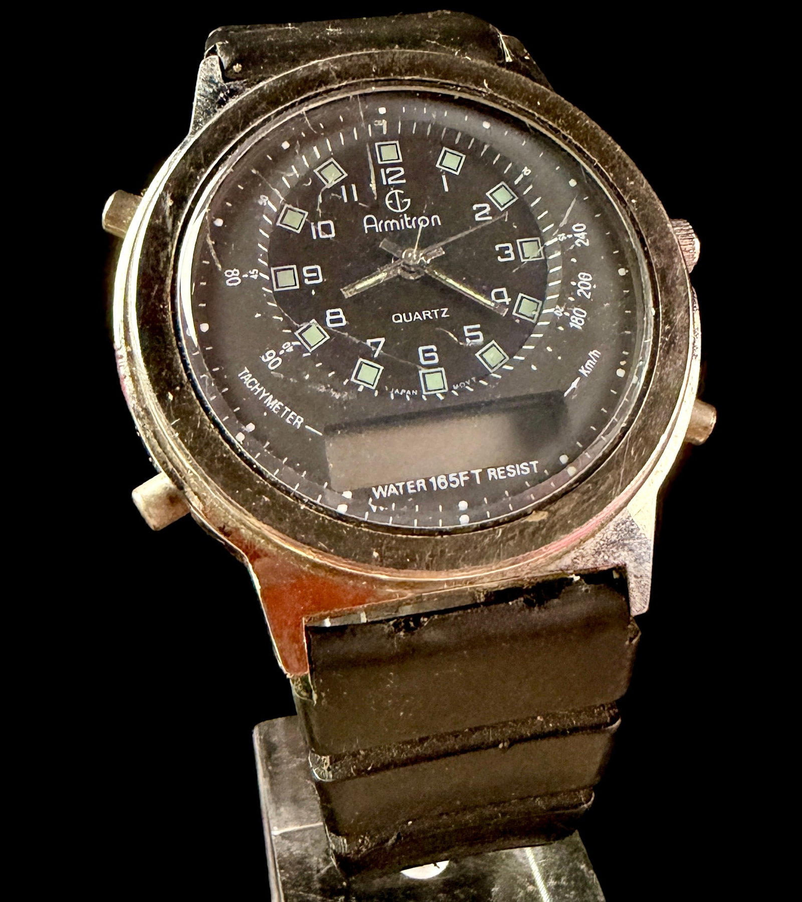 Armitron Ana-Digi Quartz Tachymeter Wristwatch Reference 20/3479A TL11: This vintage Armitron wristwatch features a dual analog and digital (ana-digi) display. The black dial is configured with luminescent square hour markers, white Arabic numerals, and an outer