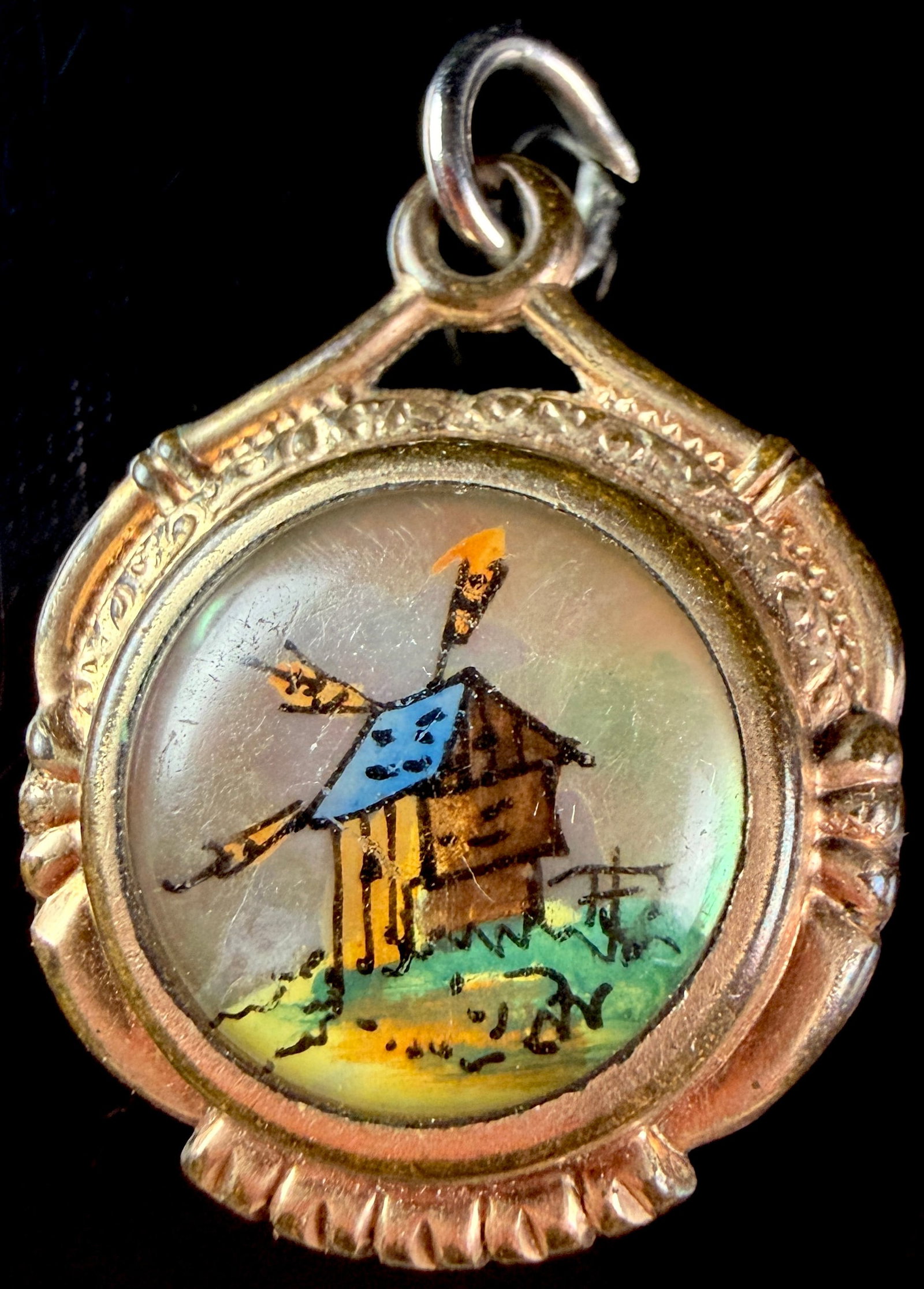 Essex Crystal and Goldstone Double-Sided Windmill Watch Fob Charm: This Essex crystal watch fob charm is designed as a double-sided circular pendant set in gold-tone metal. The obverse features a domed Essex crystal covering a hand-painted miniature depiction of a