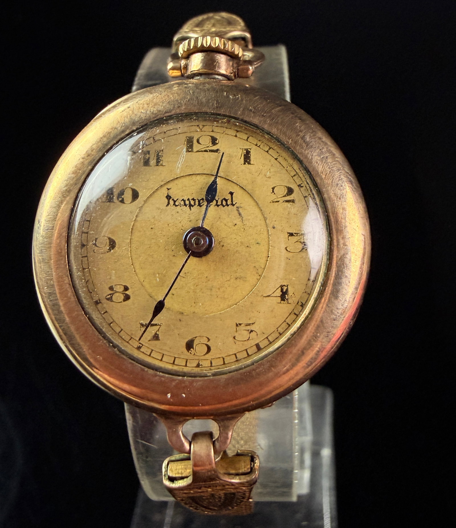 Imperial Ladies Gold Filled Manual Wind Mesh Bracelet Wristwatch: This antique ladies' transitional wristwatch features a circular gold-filled case and an ornate gold-filled mesh bracelet. The aged gold-tone dial is signed Imperial in stylized script and features a