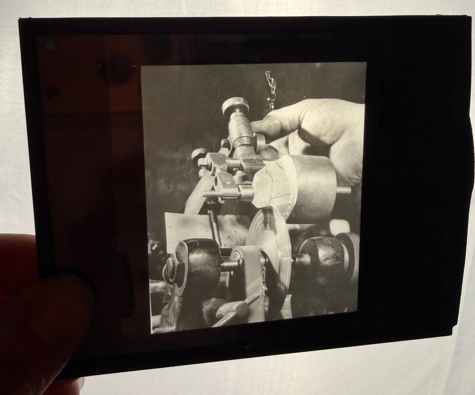 Six Vintage Glass Lantern Slides Depicting Diamond Cutting and Famous Gemstones: Six vintage silver gelatin glass lantern slides focused on industrial gemology and the diamond cutting process. The subject matter includes photographic studies of hands operating specialized machiner