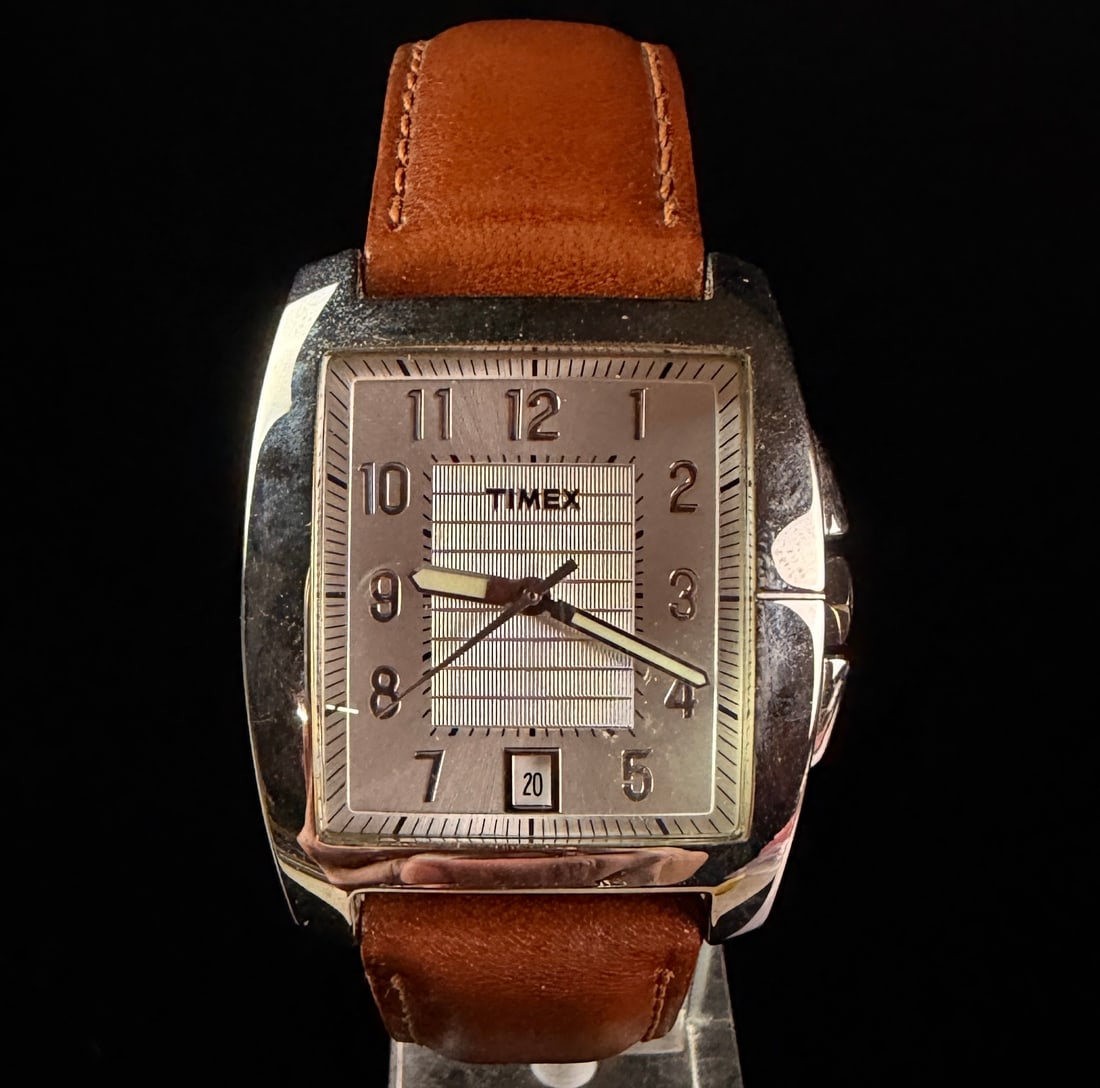 Timex Men's Model T29371 Rectangular Silver Tone Dial Quartz Wristwatch: Timex Model T29371 rectangular quartz dress watch. The watch features a silver-tone sunray dial with a textured rectangular central field. Dial elements include applied silver-tone Arabic numeral hour
