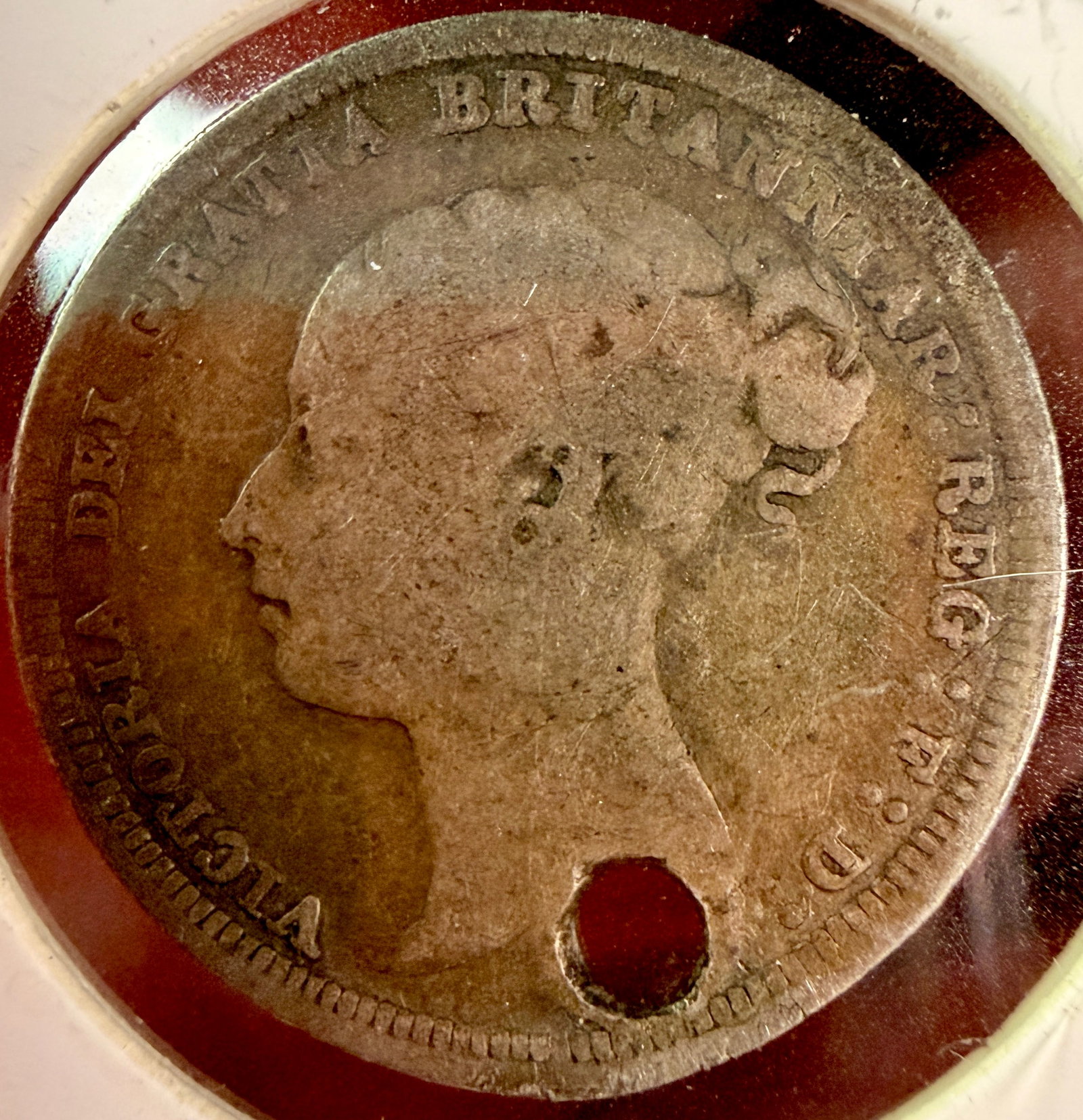 UK 1887 Queen Victoria Silver Sixpence: A UK sterling silver sixpence dated 1887. The obverse features the Young Head portrait of Queen Victoria facing left with her hair tied in a bun. The surrounding Latin legend reads VICTORIA DEI GRATIA