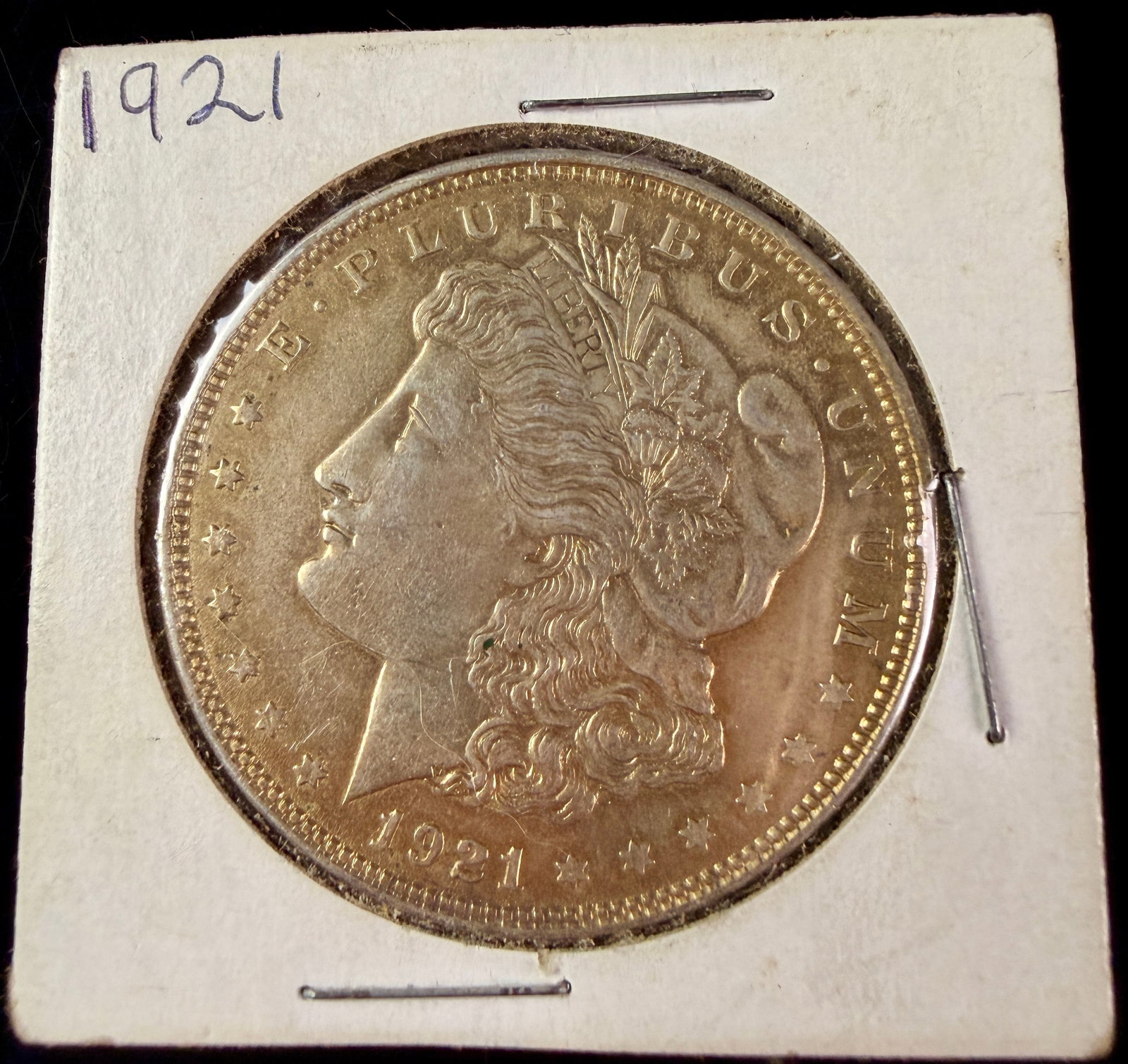 1921-S US Morgan Silver Dollar: A 1921-S US Morgan silver dollar struck at the San Francisco Mint. The obverse features a left-facing profile of Liberty encircled by thirteen stars and the legend E PLURIBUS UNUM, with the date 1921 
