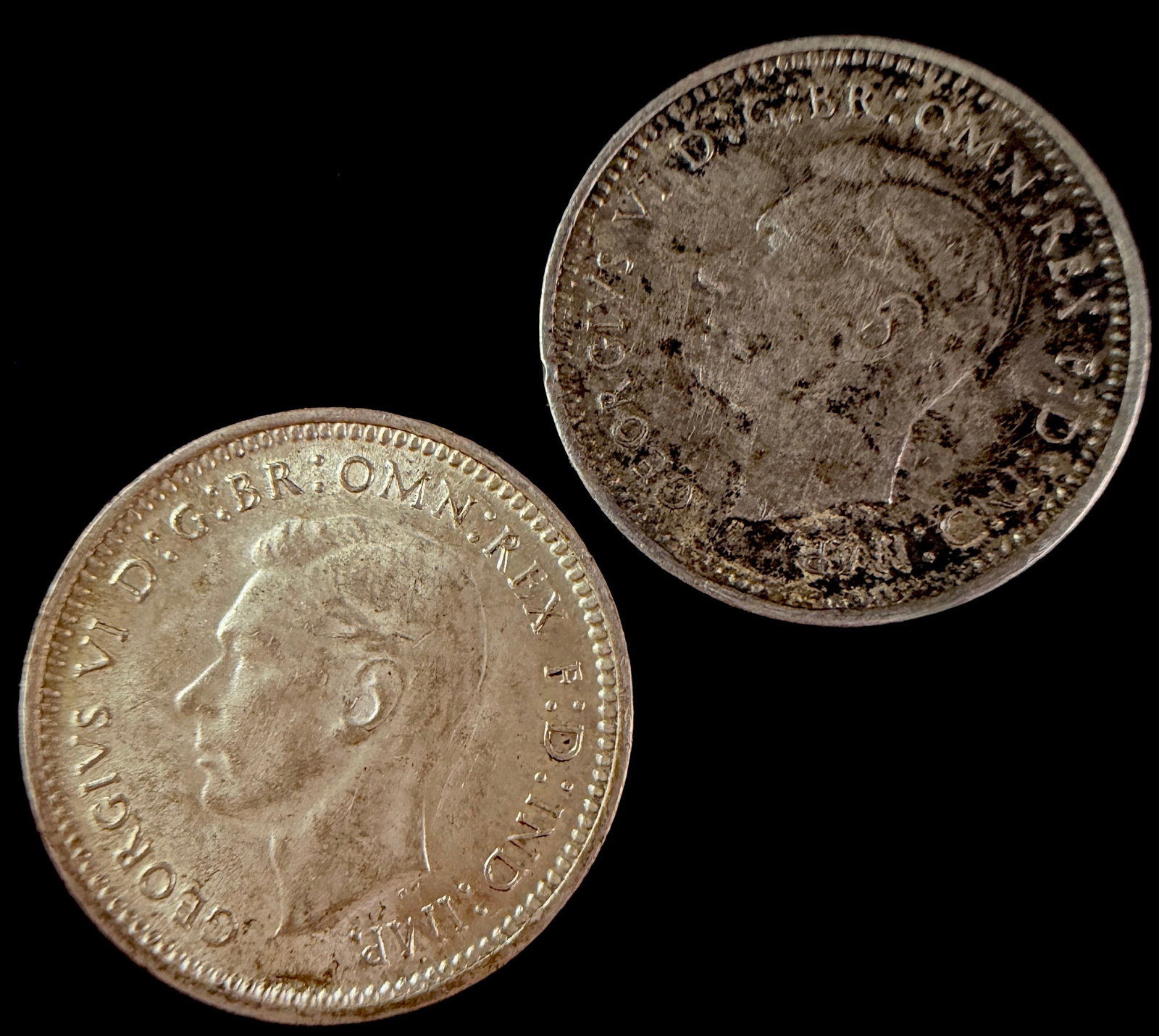 A Pair of Australian 1943-D Silver Three Pence Coins: A pair of sterling silver three pence coins issued for circulation in Australia. Both coins are dated 1943 and feature a small D mint mark on the reverse above the ribbon, identifying them as products
