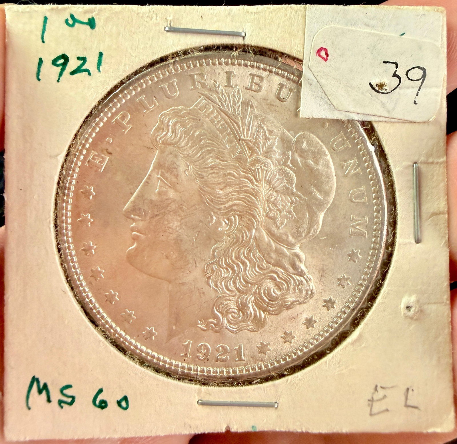 US 1921 Morgan Silver Dollar: This US silver dollar, dated 1921, is composed of 90 percent silver and 10 percent copper. The coin features the Morgan design type on the obverse and a heraldic eagle on the reverse. It was produced 