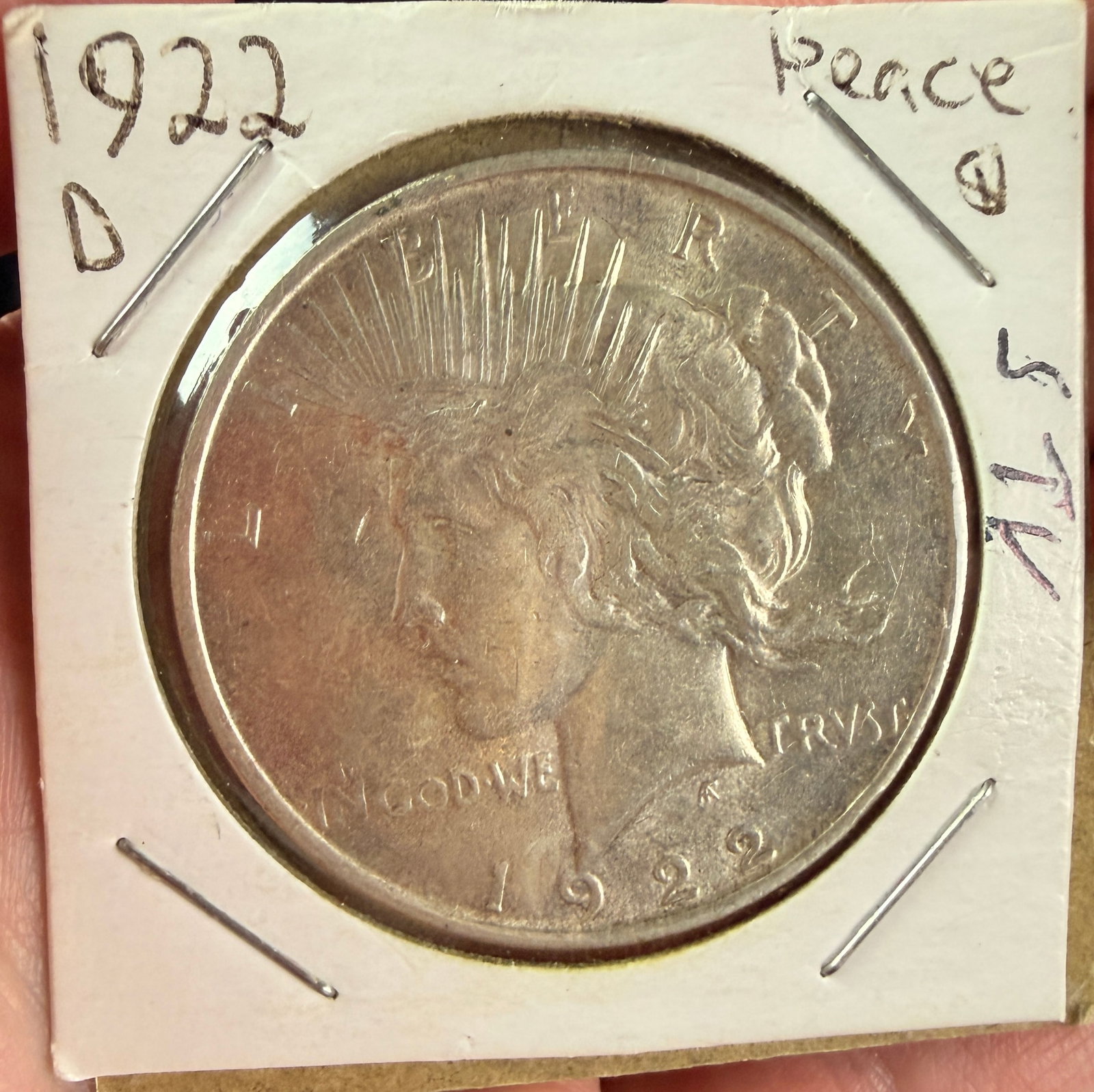 US 1922-D Peace Silver Dollar: This US silver Peace Dollar was struck at the Denver Mint in 1922. The obverse features the head of Liberty in a radiate crown with the inscriptions LIBERTY, IN GOD WE TRVST, and the date 1922. The re