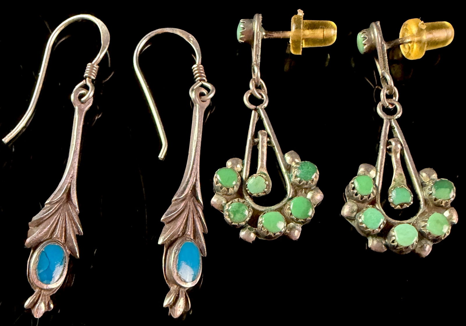 An Assortment of Southwestern Style Silver and Turquoise Earrings: A collection of matched earrings featuring Southwestern design motifs and turquoise accents. The first set consists of a pair of leaf-form drop earrings crafted in sterling silver. Each earring is set