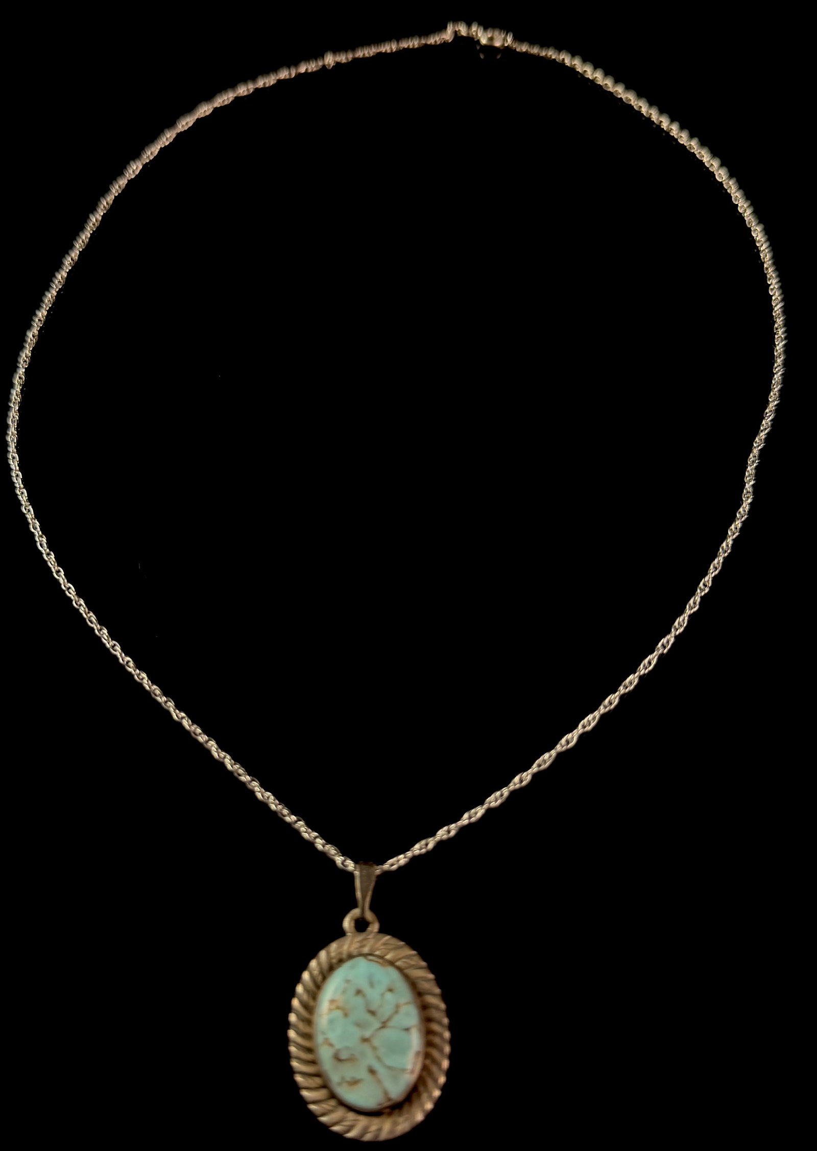 Sterling Silver Rope Twist Pendant Necklace with Oval Larimar Cabochon: A vintage sterling silver pendant necklace featuring a central oval cabochon gemstone. The gemstone displays a marbled pale blue and white coloration with a brown matrix, consistent with Larimar. The 