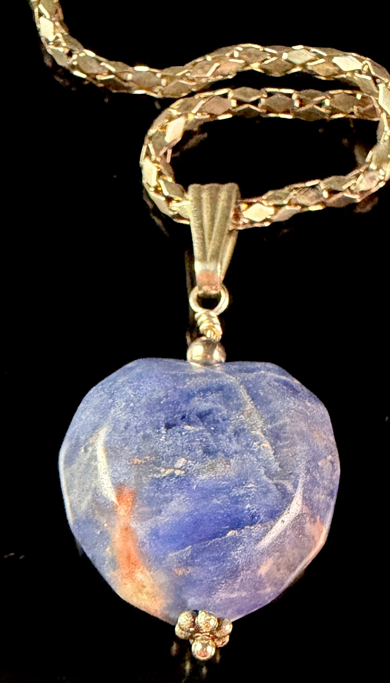 Sterling Silver and 14 Karat Gold-Filled Necklace with Rough-Cut Heart-Shaped Blue Stone Pendant: This necklace features a focal pendant crafted from a large, rough-cut heart-shaped stone in shades of blue and white with reddish-brown mineral inclusions. The stone is secured via a vertical wire-wr