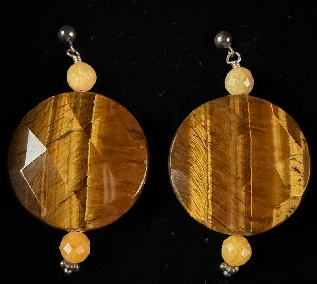 A Pair of Jay King Mine Finds Faceted Tiger's Eye Disc Drop Earrings: This pair of drop earrings features large faceted round discs of tiger's eye stone, displaying characteristic golden-brown and dark-brown chatoyant bands. Each central disc is accented above and below
