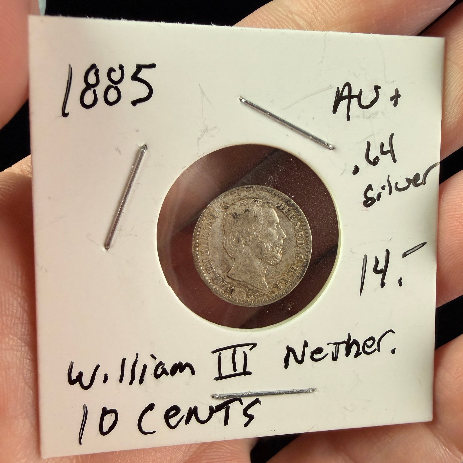 1885 NL Silver 10 Cents Coin, William III: This silver 10-cent coin from the Netherlands was struck in 1885 during the reign of King William III. The obverse features a right-facing profile of the monarch surrounded by the legend WILLEM III KO