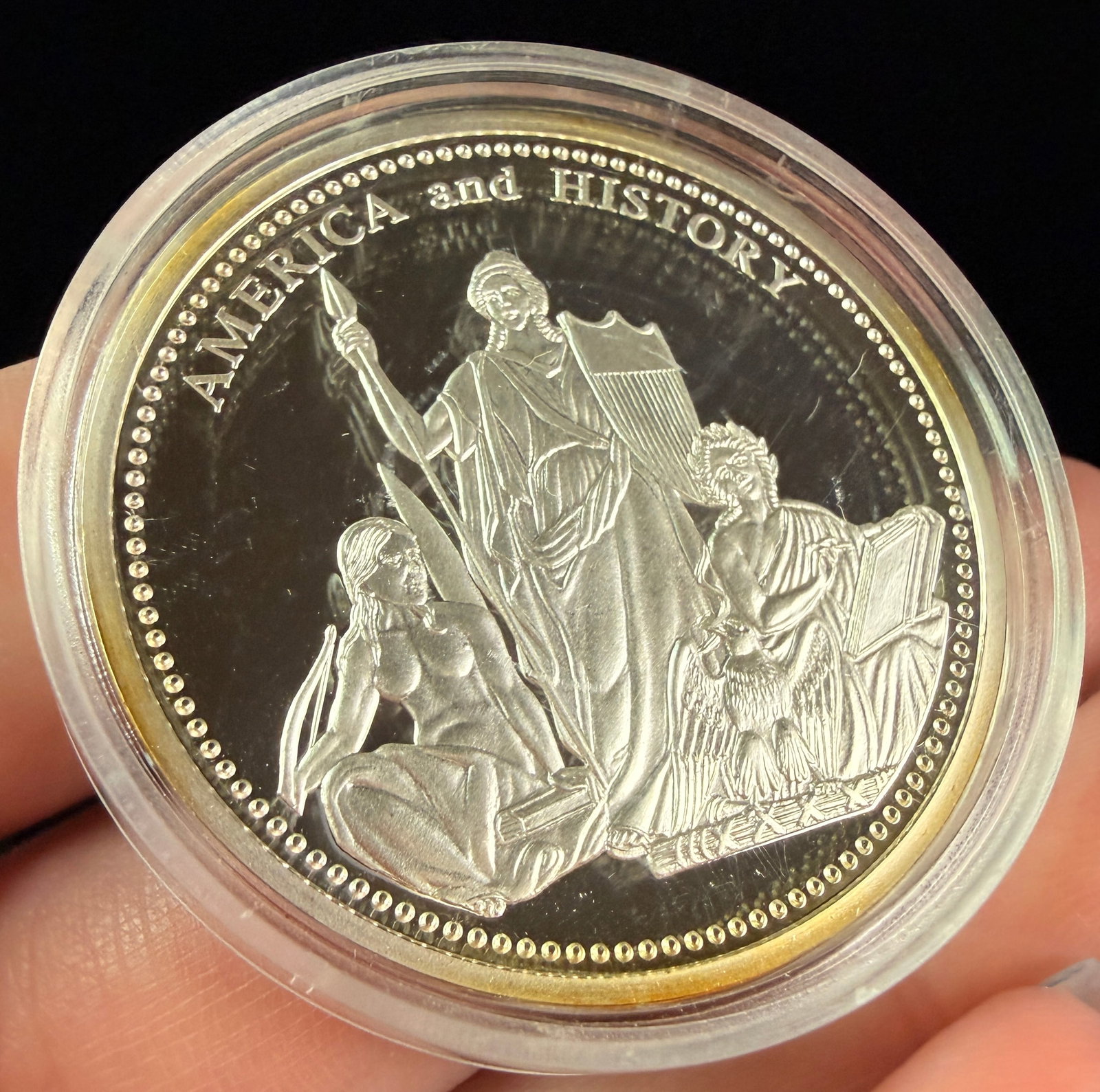 US Silver Commemorative Bullion Round, America and History: A commemorative bullion round struck in silver-toned metal, likely .999 fine silver. The obverse features an America and History allegorical design within a beaded border. The reverse depicts an