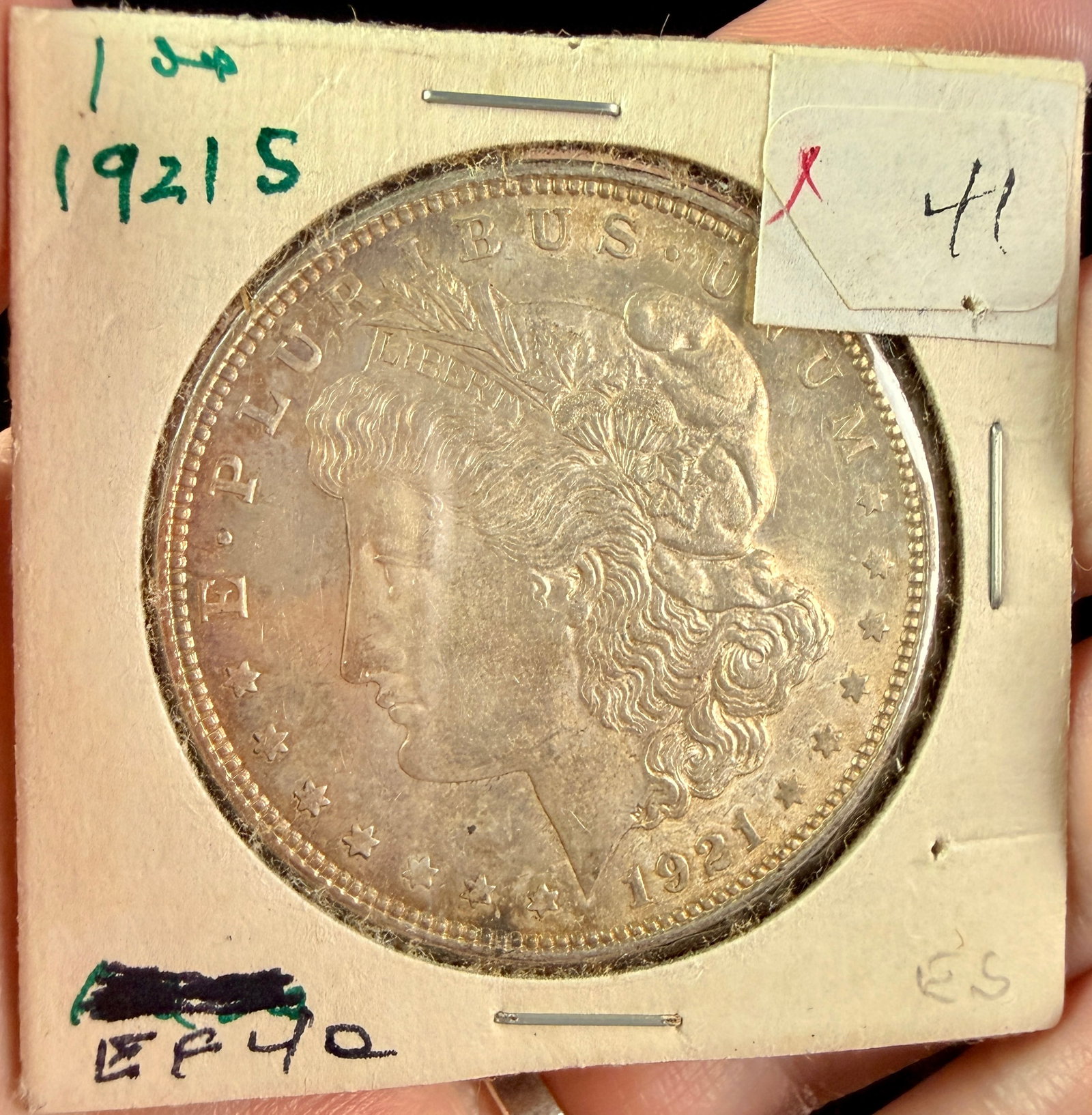 US 1921-S Morgan Silver Dollar: A US 1921-S Morgan silver dollar composed of 90% silver and 10% copper. The coin is struck with the Morgan obverse and reverse designs. An S mint mark is visible on the reverse, centered above the