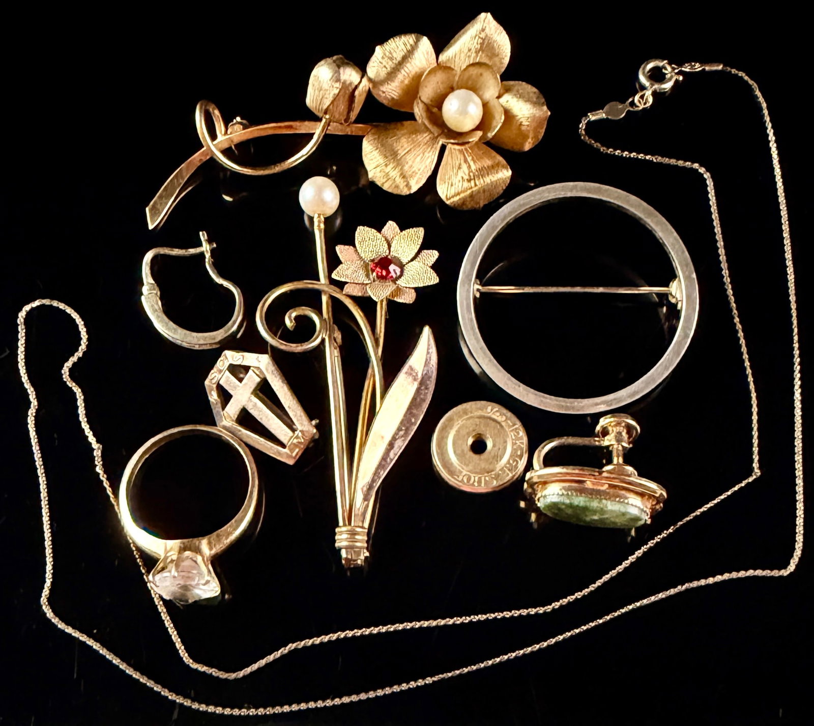 A Collection of Vintage Gold Filled Jewelry Including Wells and Van Dell Brooches: This collection of gold filled vintage jewelry includes multiple brooches, a ring, a necklace, and various components. A large brushed finish flower brooch features a central faux pearl and bears an o