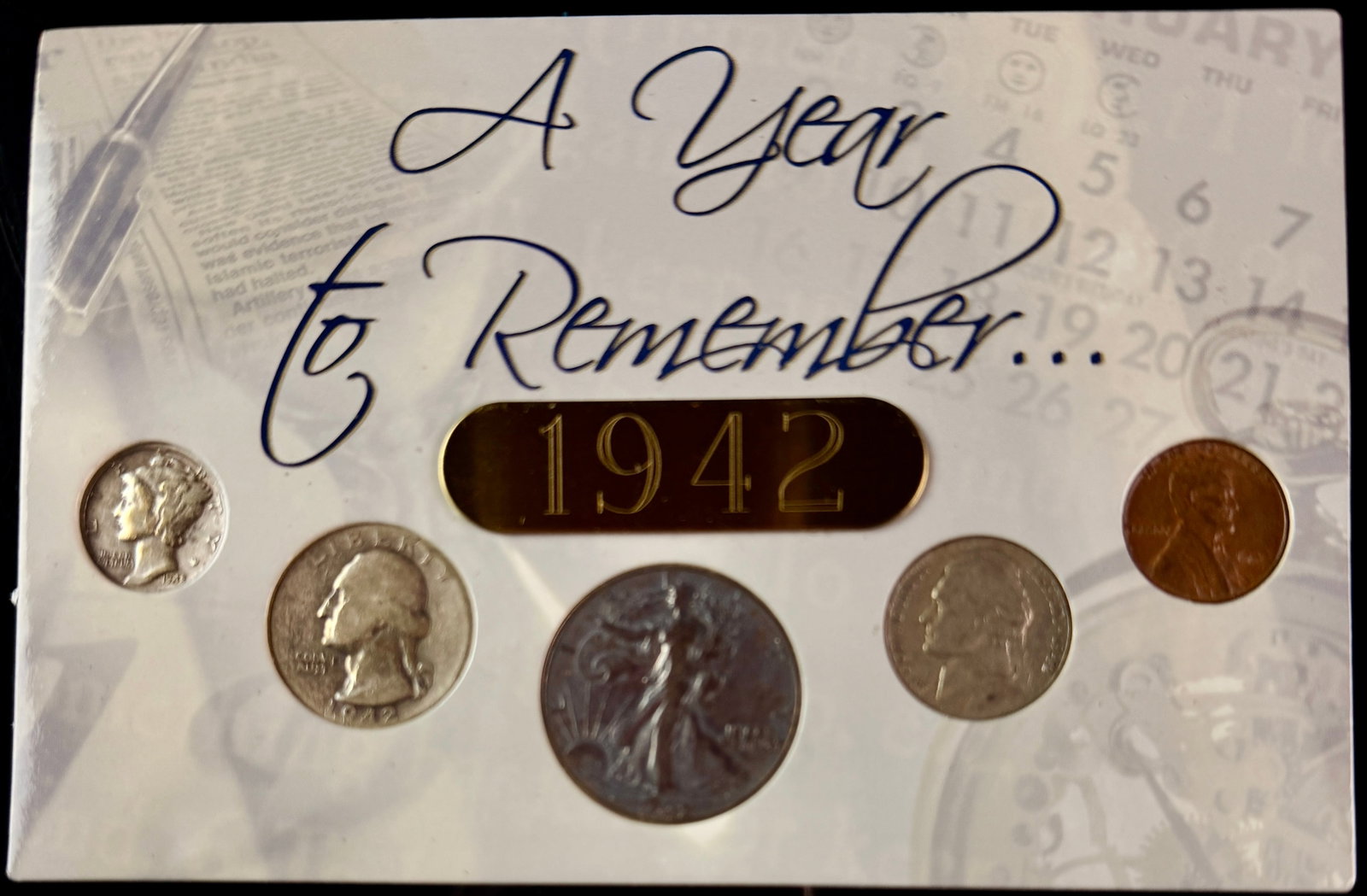 A Collection of US 1942 Philadelphia Mint Coins in A Year to Remember Display Card: A collection of US coins minted in 1942, consisting of five circulating denominations struck at the Philadelphia Mint. The set includes a 90 percent silver Walking Liberty half dollar, a 90 percent si
