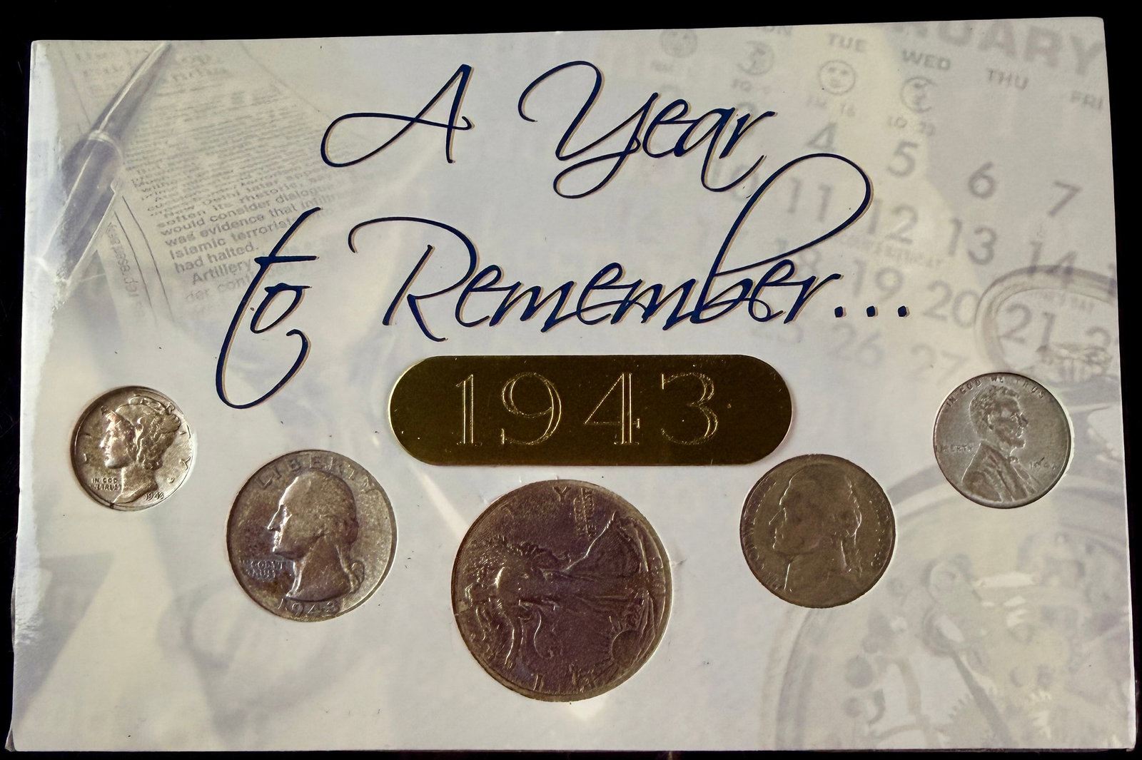US 1943 Five Coin Year Set in A Year To Remember Display: A set of five United States coins issued in 1943, presented in a printed cardboard display card titled A Year To Remember... 1943. The set includes a Walking Liberty Half Dollar, a Washington Quarter,