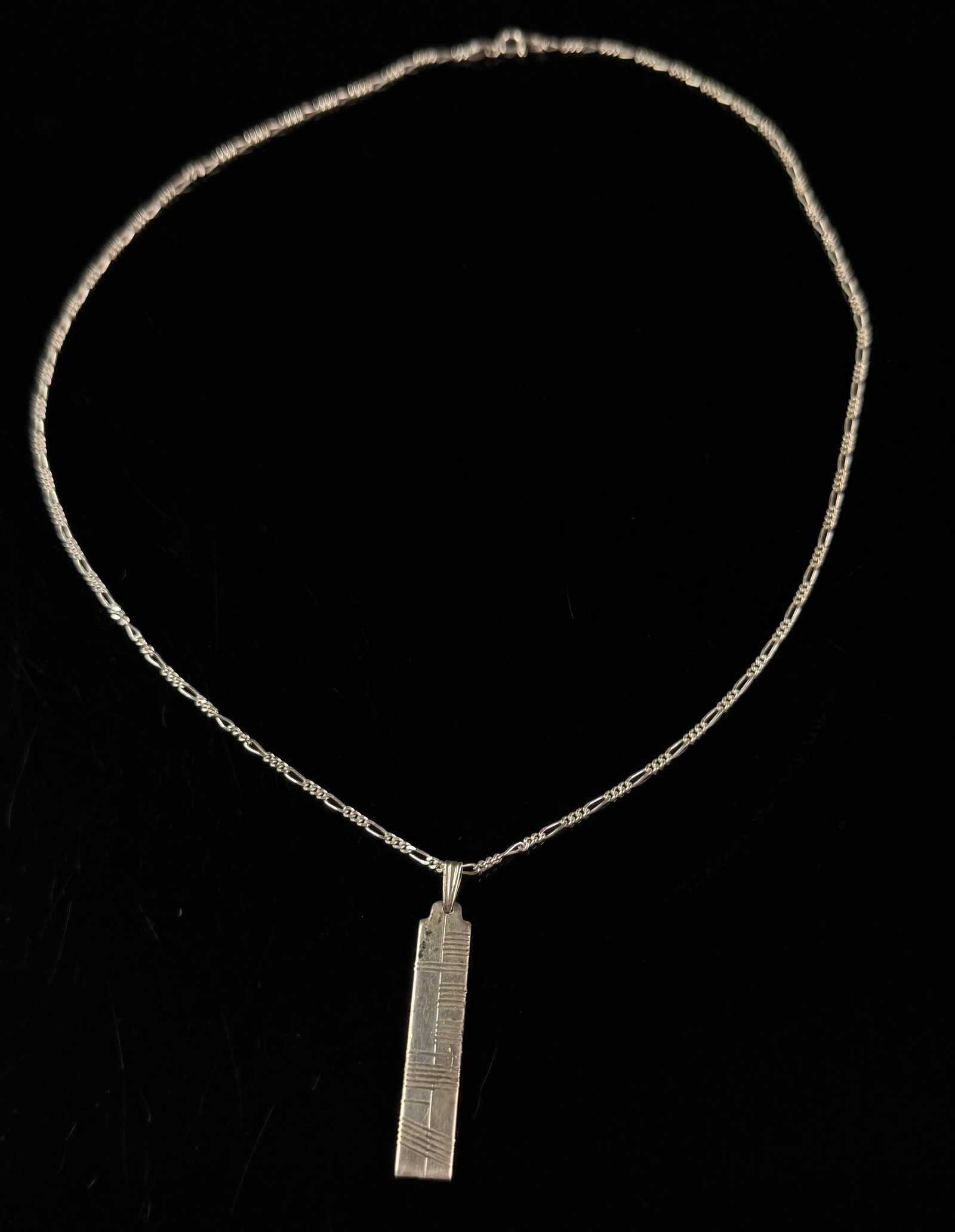 Boos Taxco Sterling Silver Brutalist Bar Pendant on Italian Figaro Chain: A sterling silver pendant necklace featuring a rectangular bar pendant with a brutalist-inspired geometric design. The pendant is constructed with a tabbed top and a fixed bail, and the front face is 