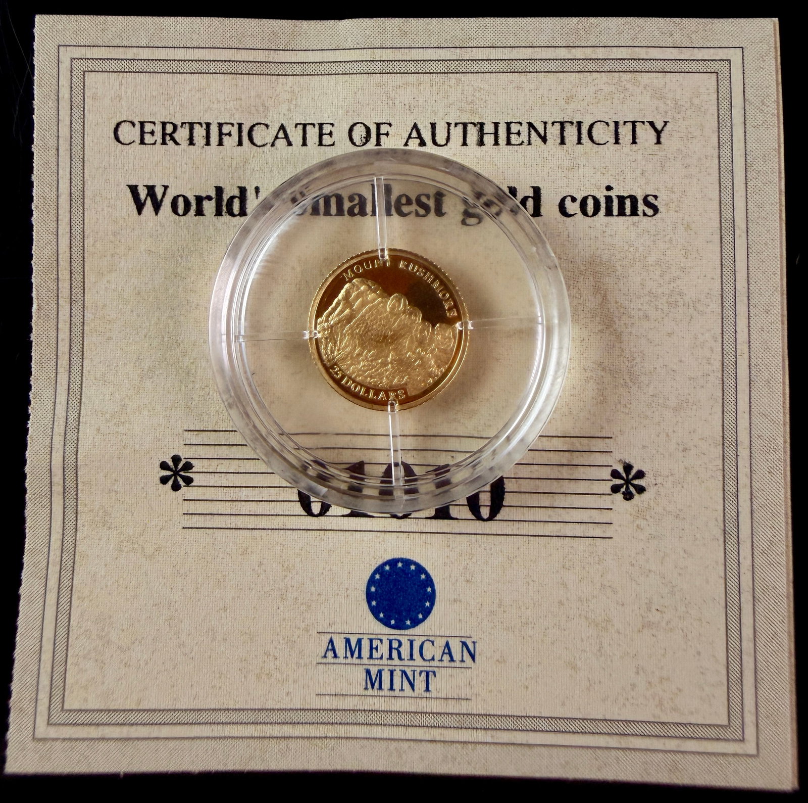 2001 Liberia 25 Dollars Mount Rushmore 24 Karat .999 Pure Gold Proof Coin and American Mint COA: A 2001 Republic of Liberia 25 Dollars gold proof coin struck in .999 fine gold. The coin is part of the World's smallest gold coins collection presented by American Mint. The obverse features the Coat